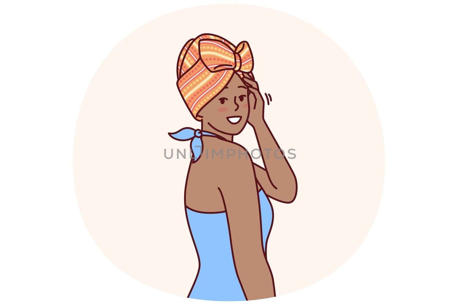Charming African American woman with traditional turban on head is dressed in blue dress for going to ethnic party. African girl smiling and looking at screen demonstrating fashion national minorities