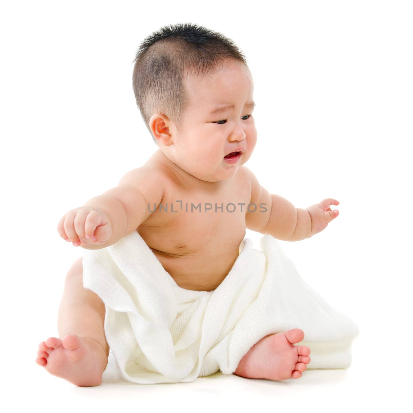 Full body unhappy Asian baby boy crying, sitting isolated on white background
