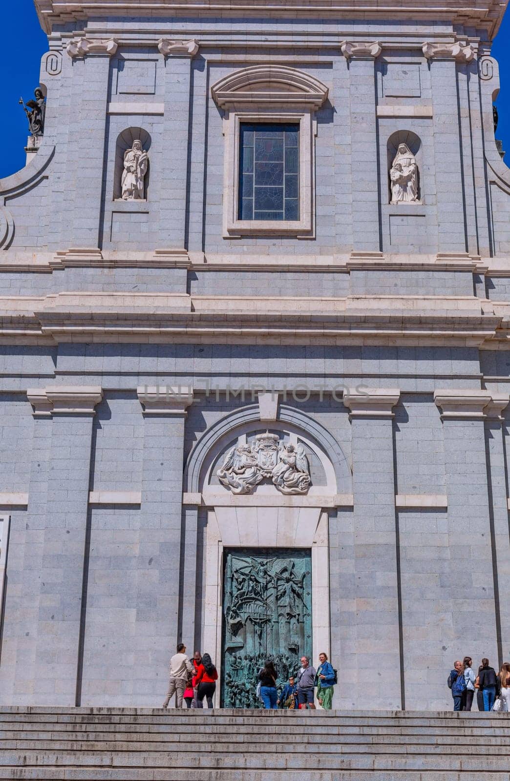 Madrid, Spain: April 24, 2024: People at the entrance of the Almudena Cathedral, Santa Maria la Real de La Almudena.
