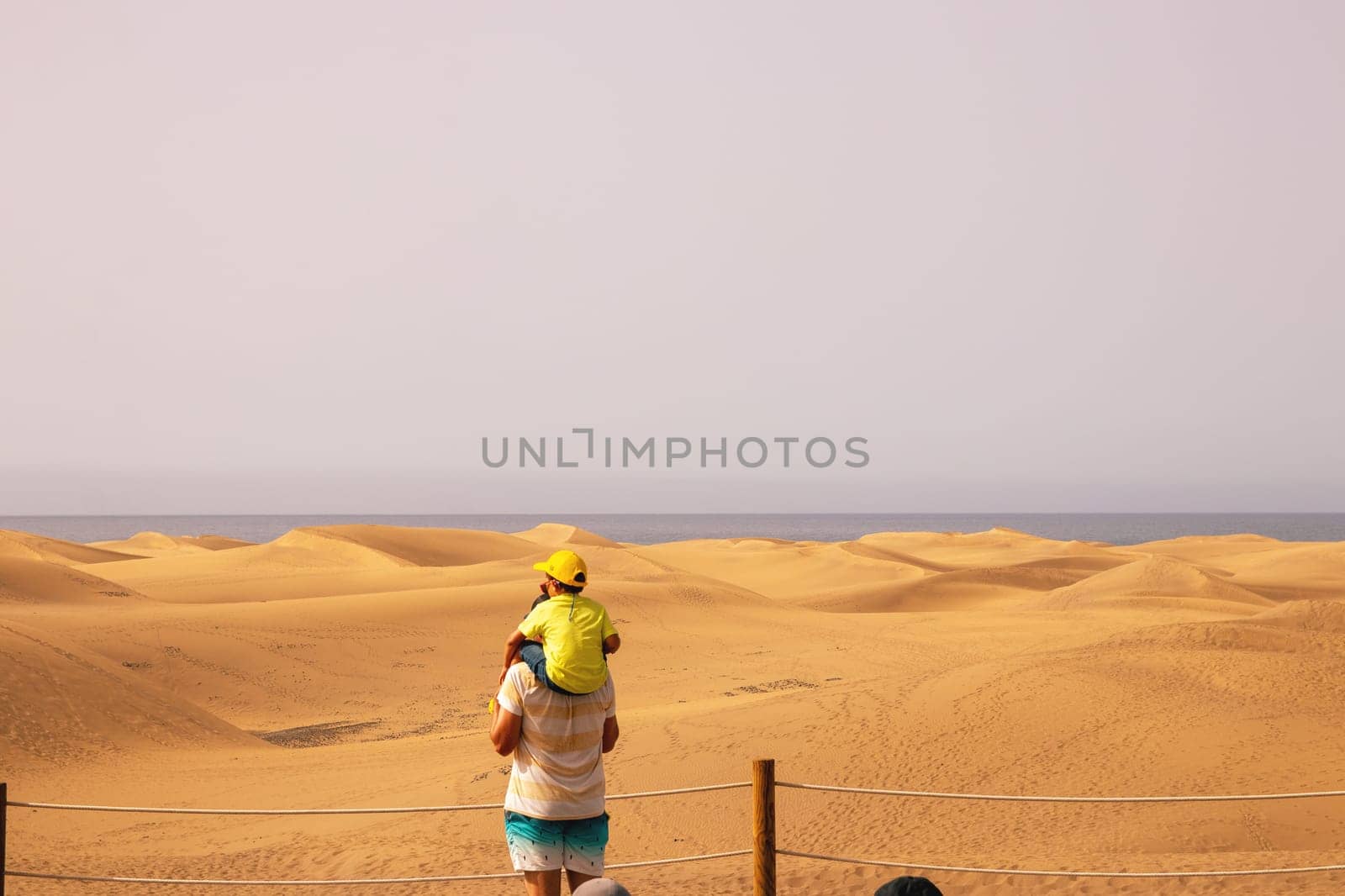 Gran Canaria, Spain, Canary Islands, Playa del Inglés - JUL 17, 2024. Tourist at a viewpoint of Dunes de Maspalomas. Maspalomas Dunes Nature Reserve.