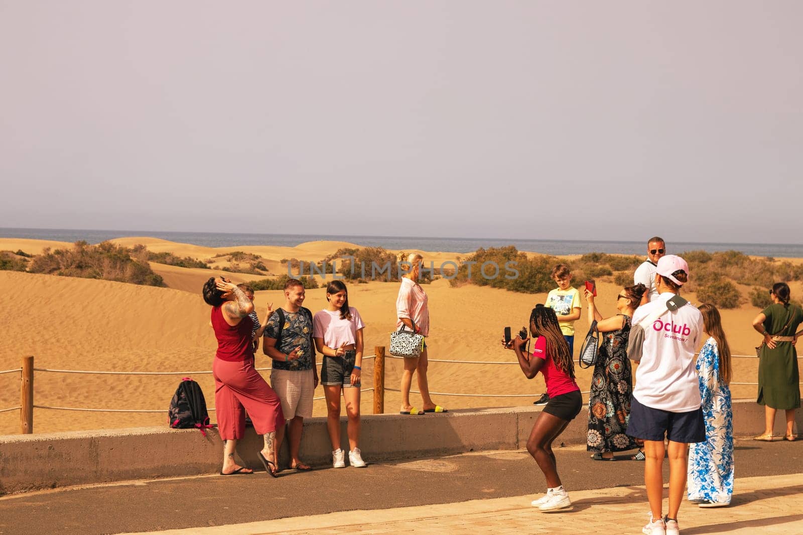 Gran Canaria, Spain, Canary Islands, Playa del Inglés - JUL 17, 2024. Tourist at a viewpoint of Dunes de Maspalomas. Maspalomas Dunes Nature Reserve.