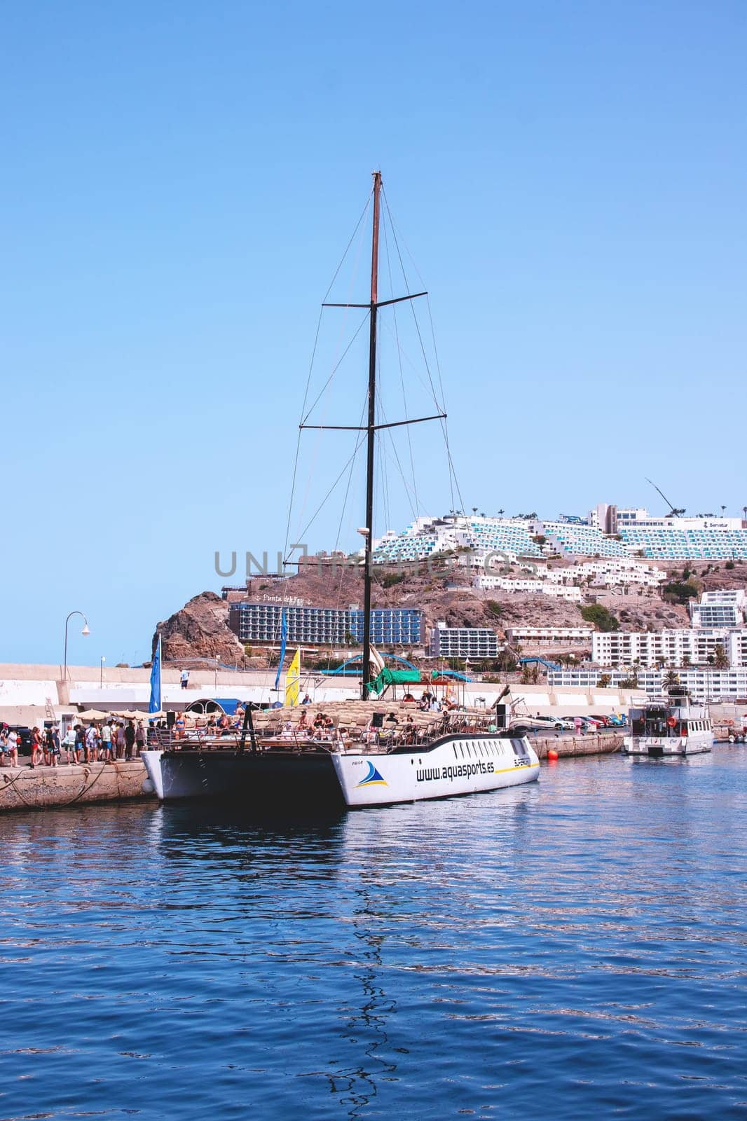 Gran Canaria, Spain, Canary Islands, Puerto Rico - Jul 17, 2024. Catamaran sailing ship in the harbour of Puerto Rico. Coastal trip for whales and dolphins.