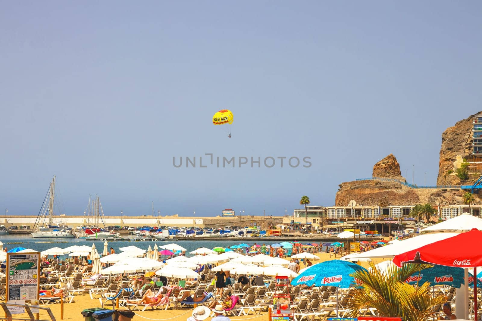 Gran Canaria, Spain, Canary Islands, Puerto Rico - Jul 18, 2024. The Playa de Porto Rico beach with a lot of tourists.