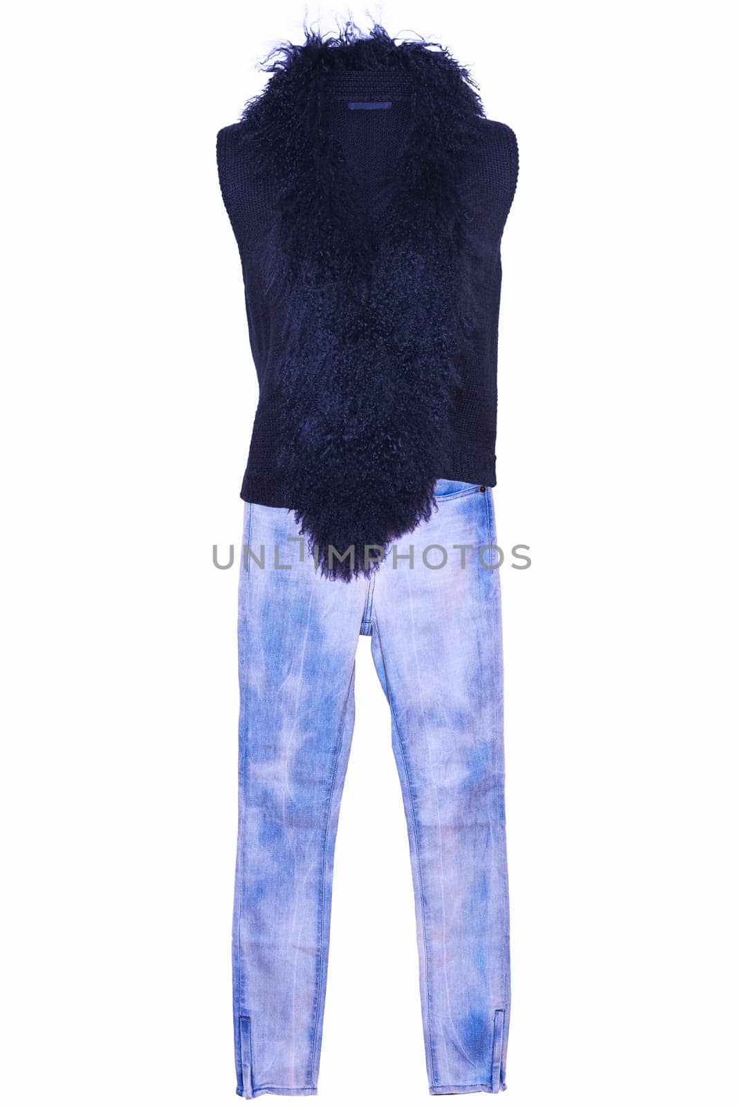 Stylish blue jeans or denim trausers and black female women vest with a large fur collar isolated on a white background. Woman fashion.