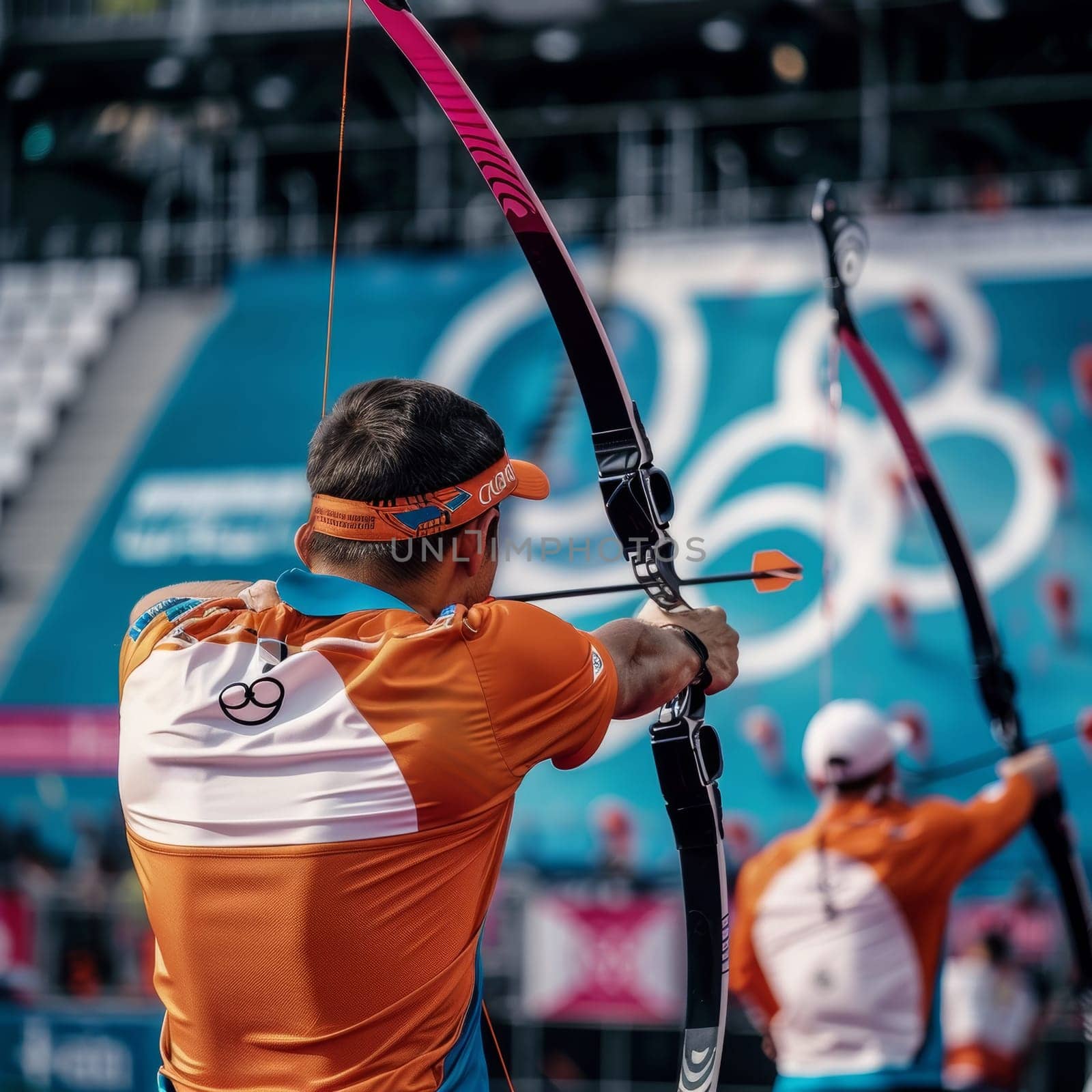 Male athlete aims arrow with intense focus during sunny outdoor competition