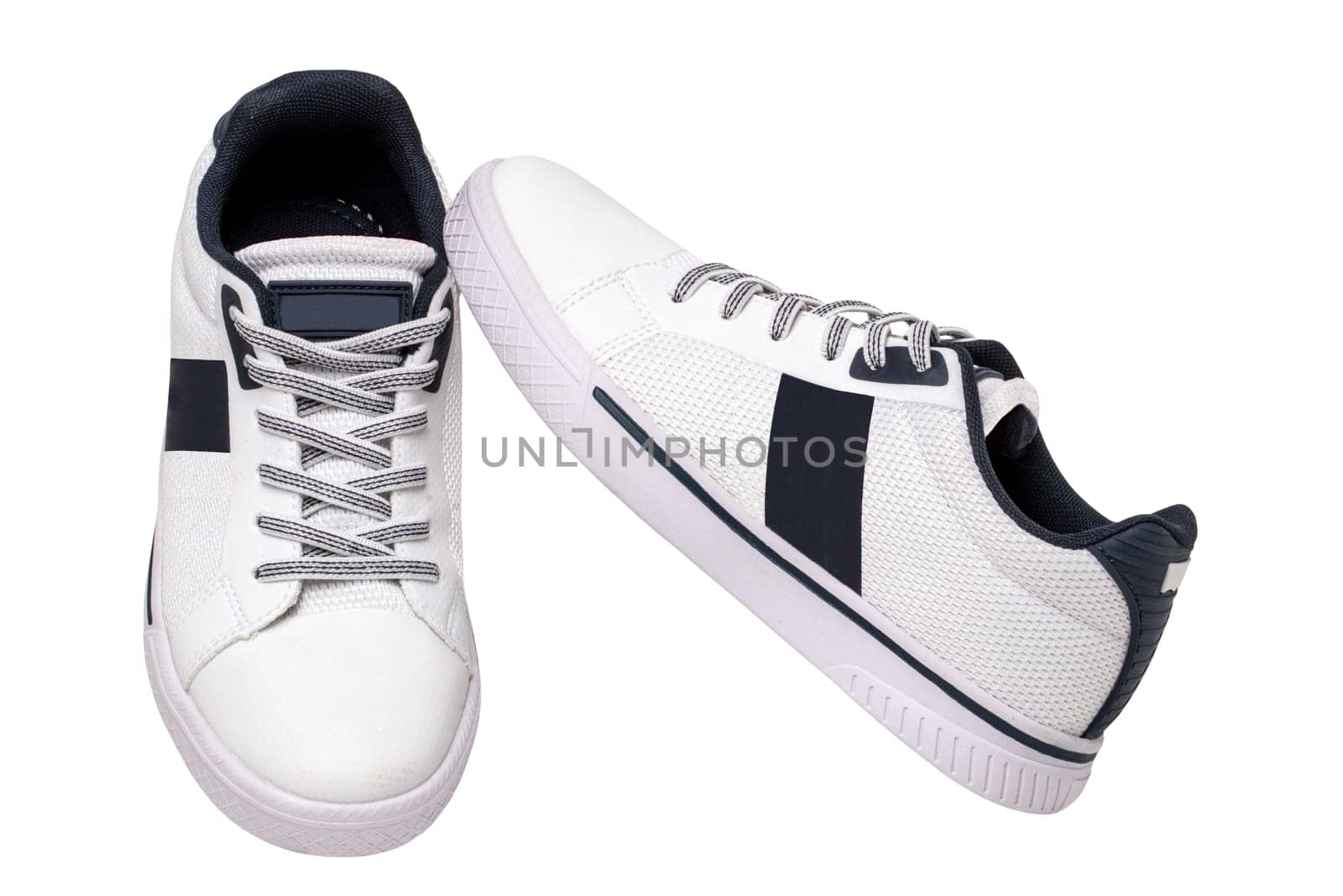 White sneakers isolated. Close-up of a pair white elegant stylish leather sport shoes isolated on a white background. Clipping path. Kids shoe fashion. Modern design footwear for workout. Macro.