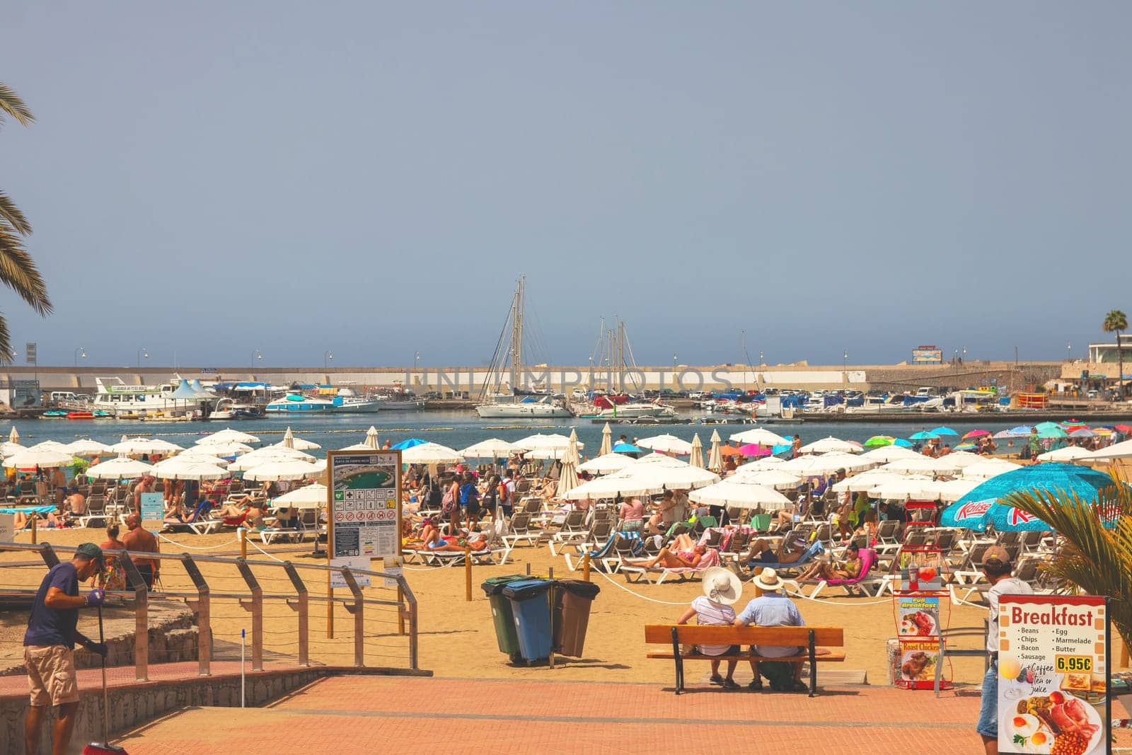 Gran Canaria, Spain, Canary Islands, Puerto Rico - Jul 18, 2024. The Playa de Porto Rico beach with a lot of tourists.