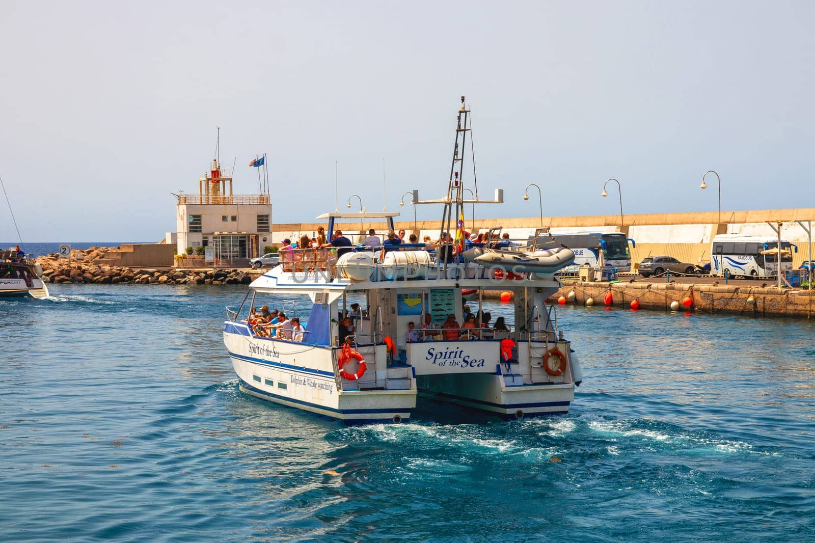 Gran Canaria, Spain, Canary Islands, Puerto Rico - Jul 18, 2024 A motor vessel leaves the harbour of Puerto Rico. Coastal trip for whales and dolphins.