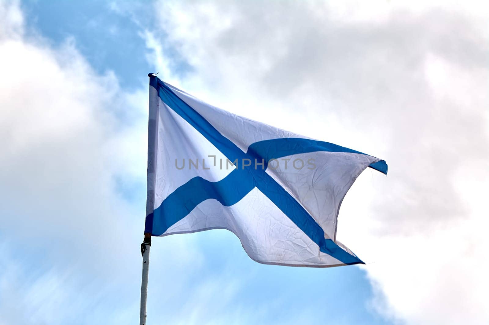the flag of the Russian navy develops against the sky. High quality photo