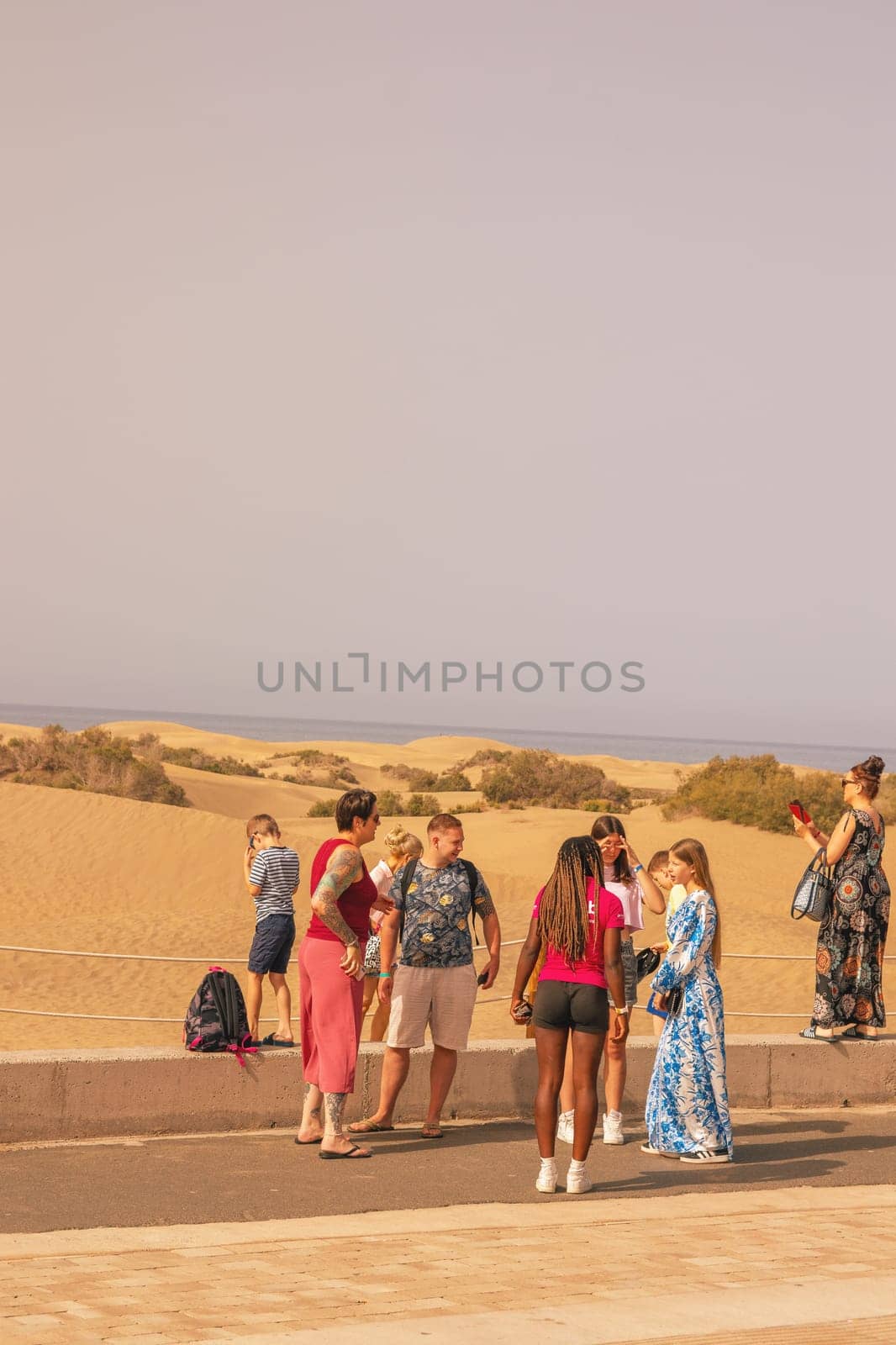 Gran Canaria, Spain, Canary Islands, Playa del Inglés - JUL 17, 2024. Tourist at a viewpoint of Dunes de Maspalomas. Maspalomas Dunes Nature Reserve.