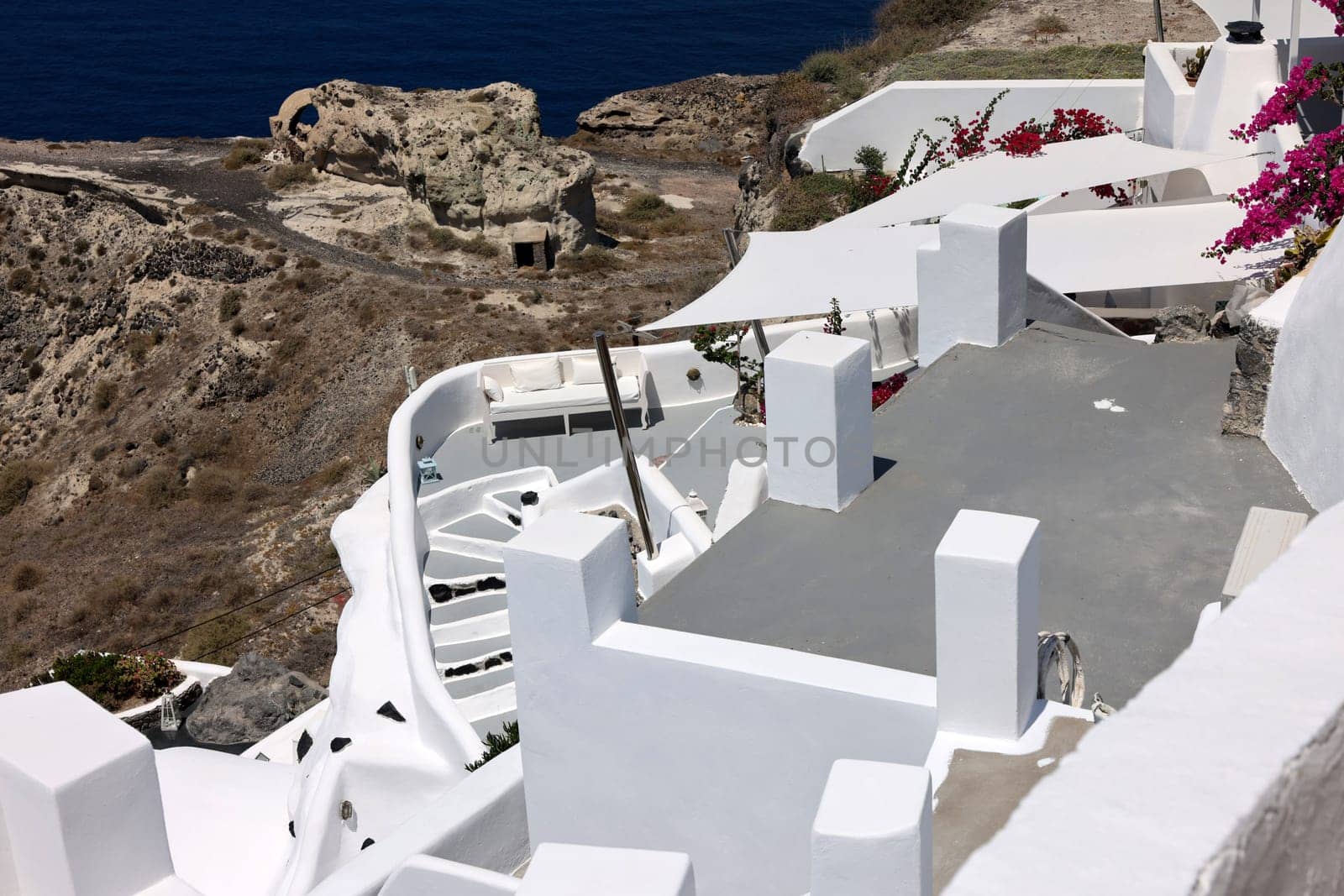 Whitewashed houses with terraces and a beautiful view in Oia on Santorini island, Greece
