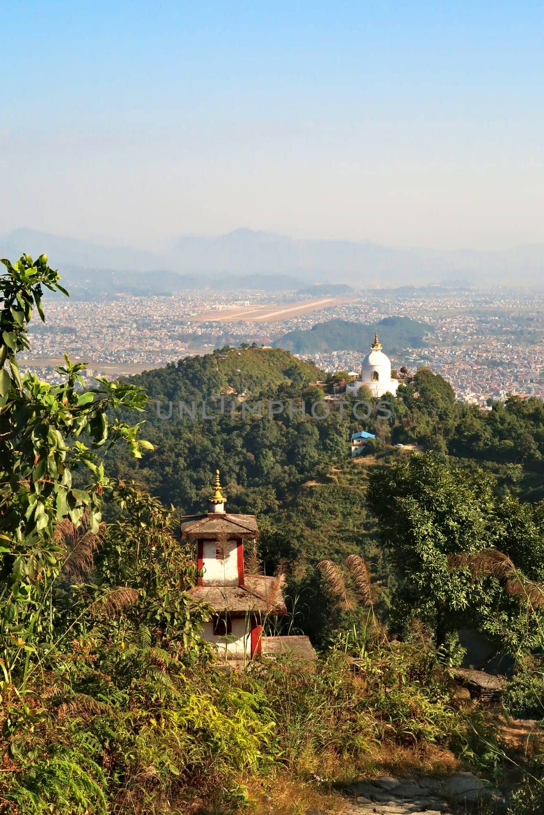 View onto the World Peace Pagoda in front ot the town of Pokhara, on the way up to the shiva statue at the Pumdikot Religious Area, Nepal 2022