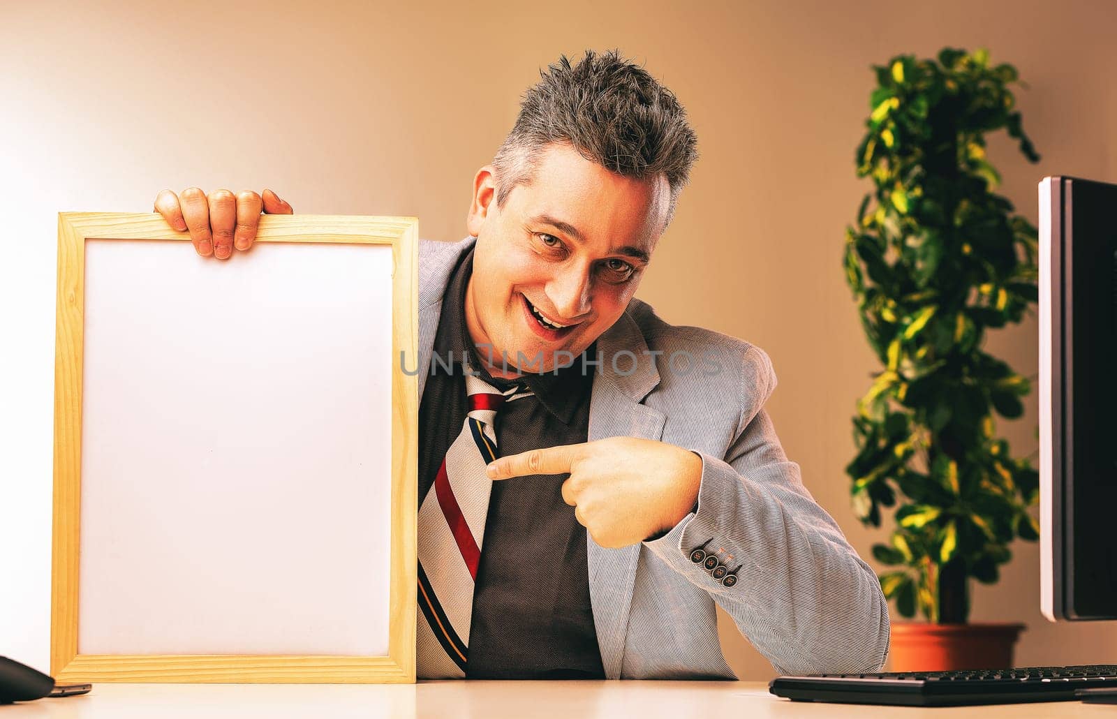 Sneaky businessman in an office, pointing at a whiteboard with a sly smile, hinting at shady sales tactics. Deception, fraud, unethical behavior