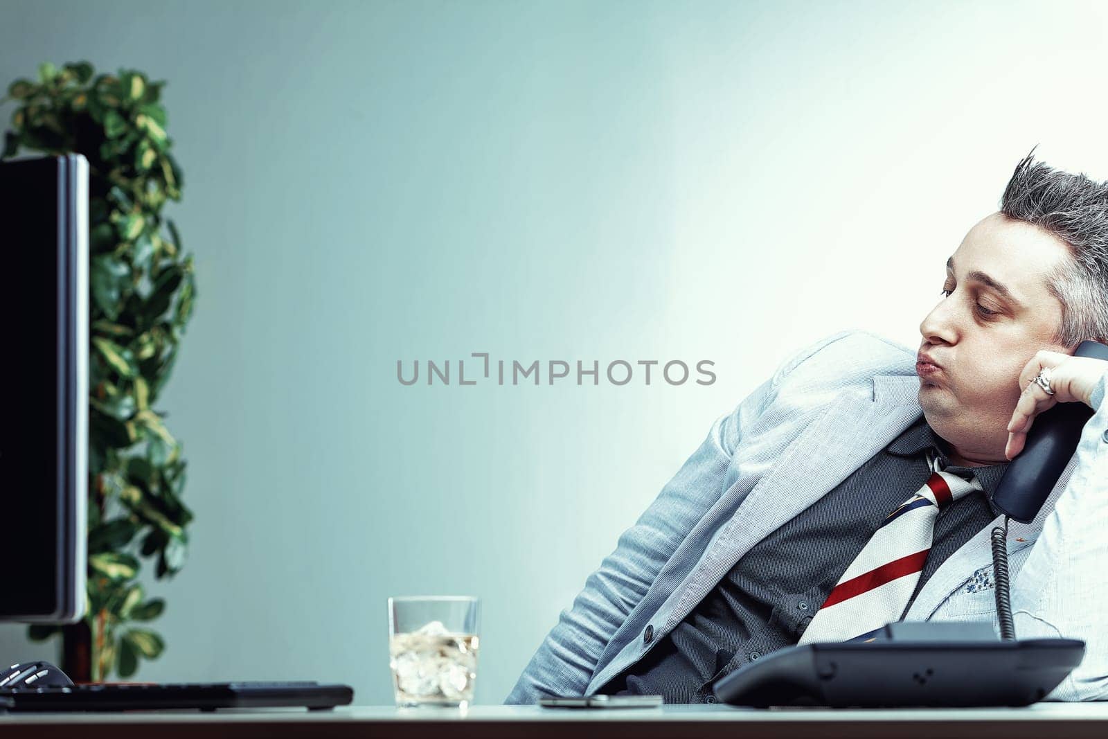 Businessman is covering his alcoholism with a facade of strength and cheerfulness while at work issues of alcoholism in the workplace