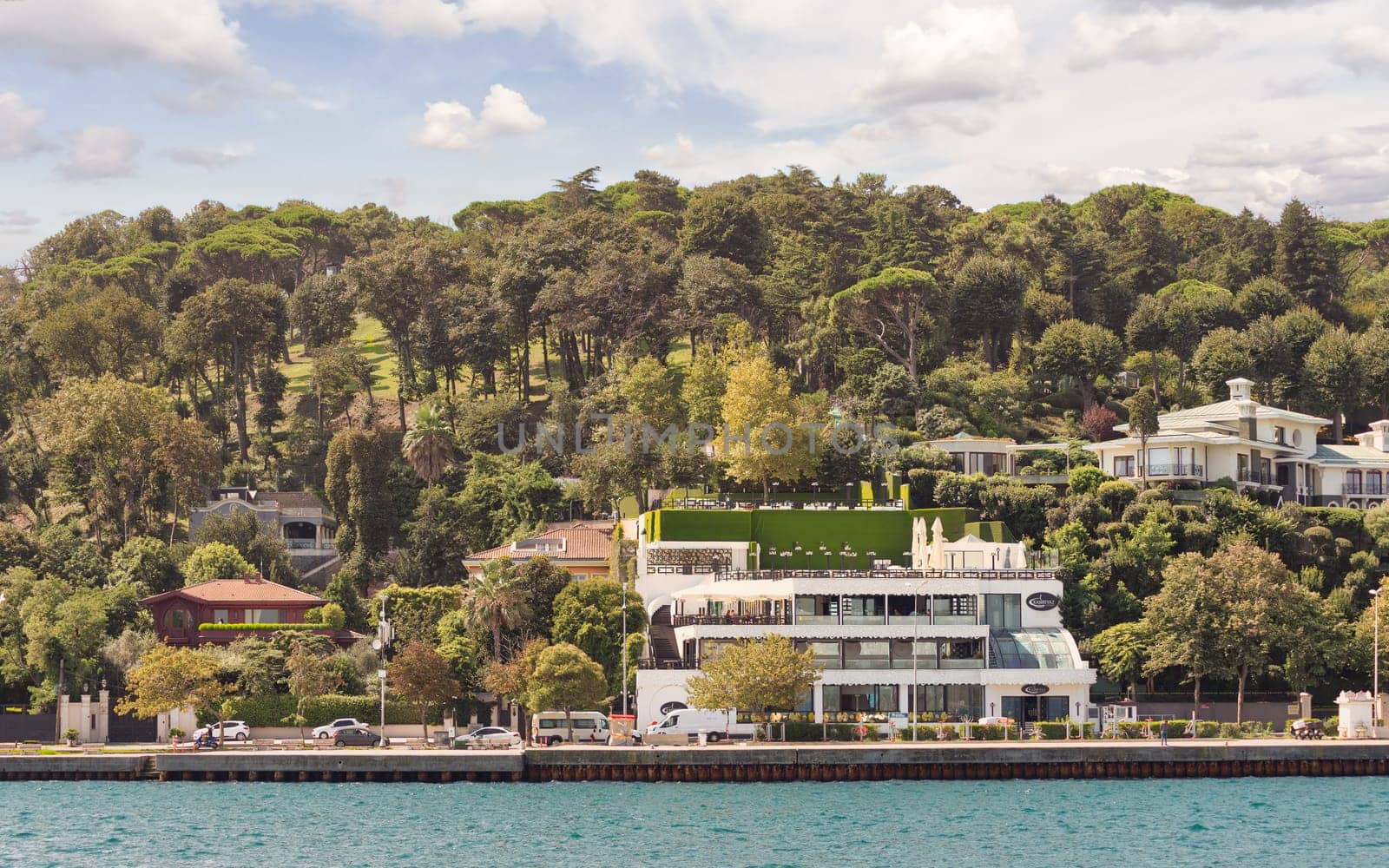 Istanbul, Turkey - August 29, 2022: Luxurious houses line the European shore of the Bosphorus Strait under a clear sky
