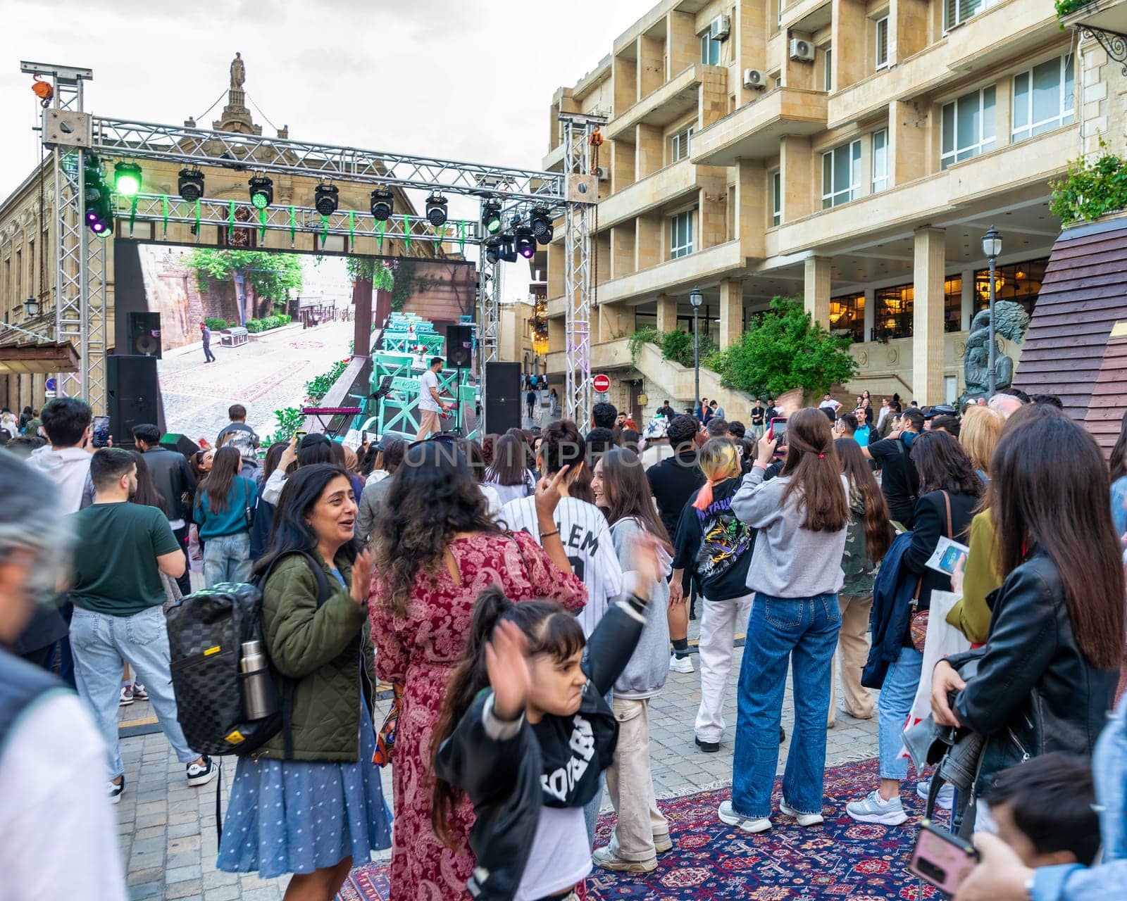Baku, Azerbaijan - May 4 2024: Crowd gathers for a concert at the first National Carpet Festival of Azerbaijan. The event takes place in the Old Town, or Icherisheher, the historic walled city