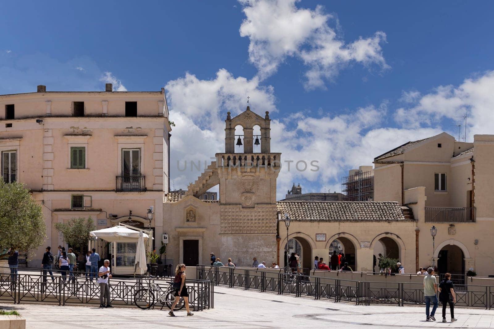 Italy, Matera - May 22, 2024: Bell tower of Mater Domini church and portico Three Arches in Vittorio Veneto Square