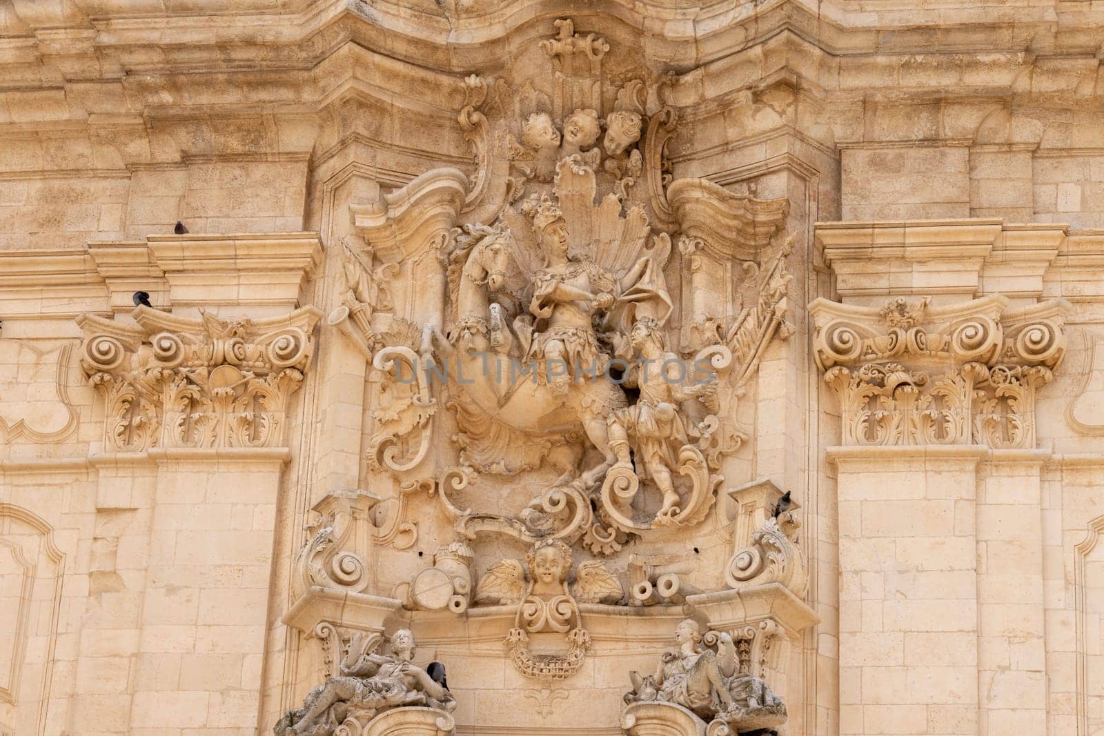 Martina Franca, Italy, Apulia - May 20, 2024: Decorative facade of baroque Basilica of San Martino (Basilica di San Martino), located in Plebiscito Square (Piazza Plebiscito)