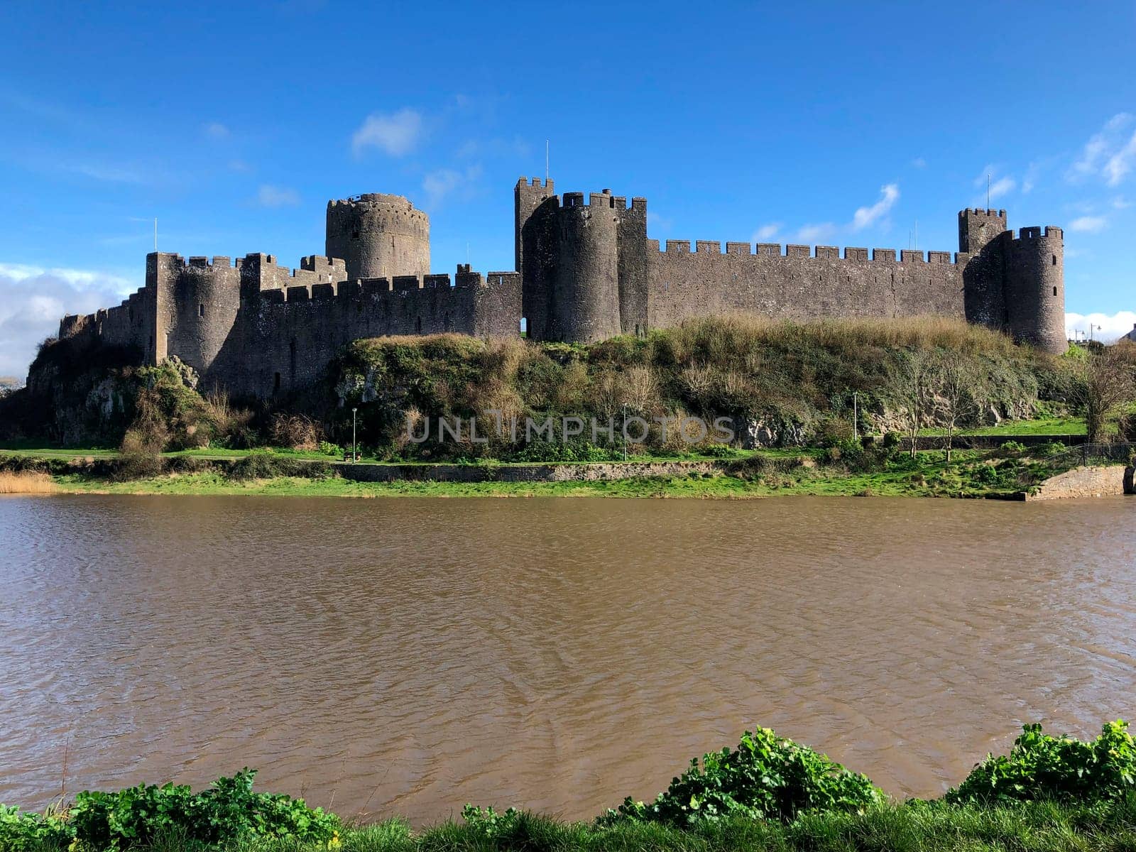 Pembroke Castle - medieval castle in Pembroke, Pembrokeshire, Wales. The castle was the original family seat of the Earldom of Pembroke. A Grade I listed building, it underwent major restoration during the early 20th century.