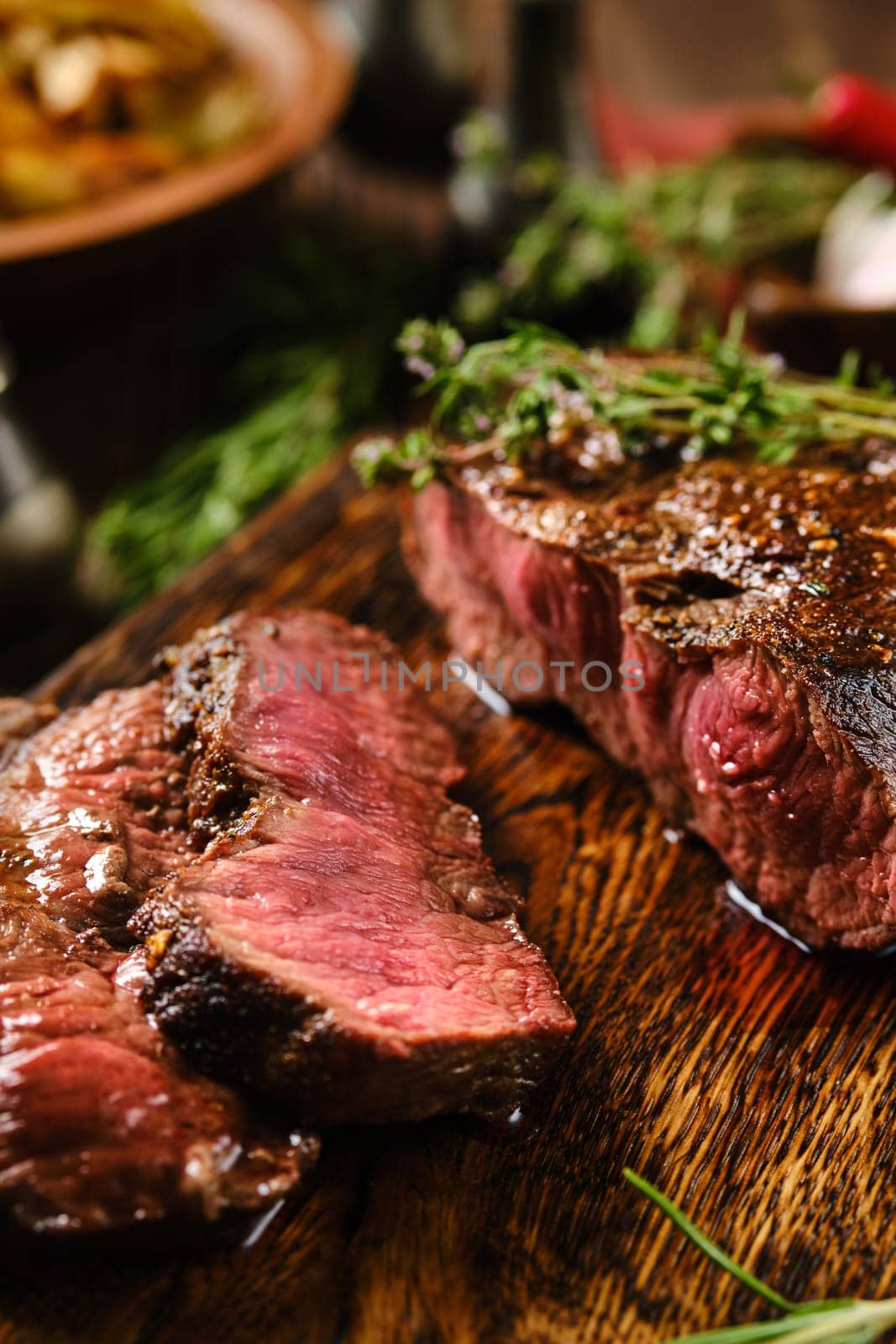 Close-up view of juicy grilled top blade beef steak cut on slices