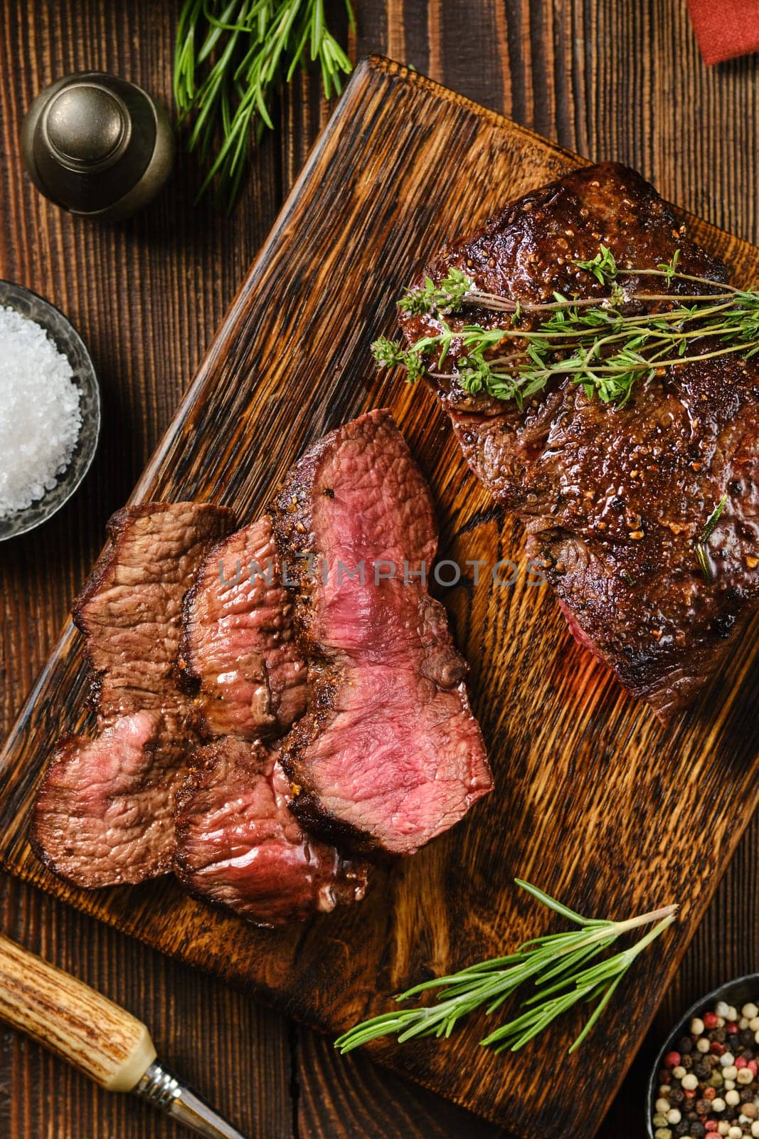 Close-up overhead view of grilled top blade beef steak cut on slices