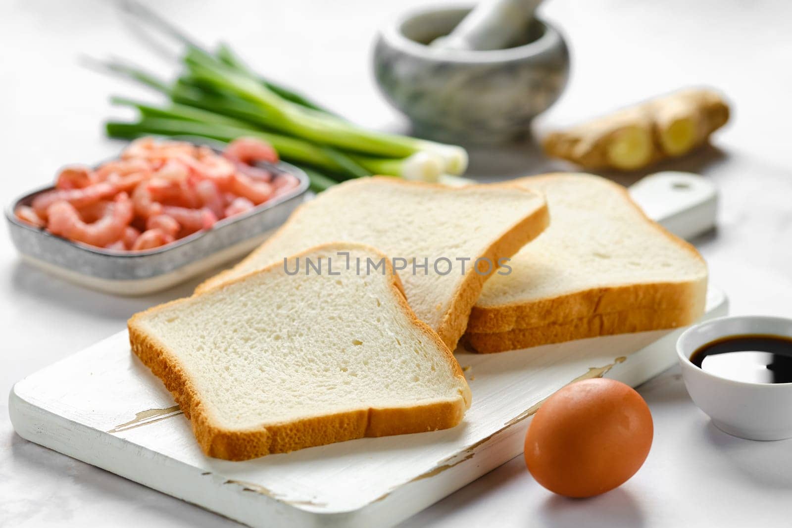 Slices of bread for toasts and ingredients for healthy food on a table
