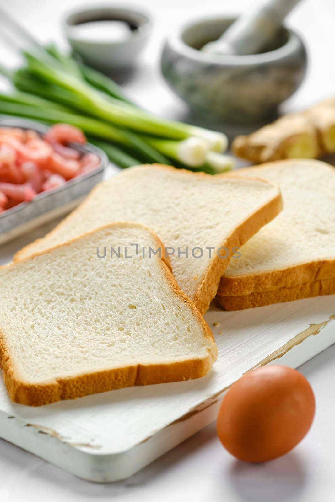 Close-up view of slices of bread for toasts and ingredients
