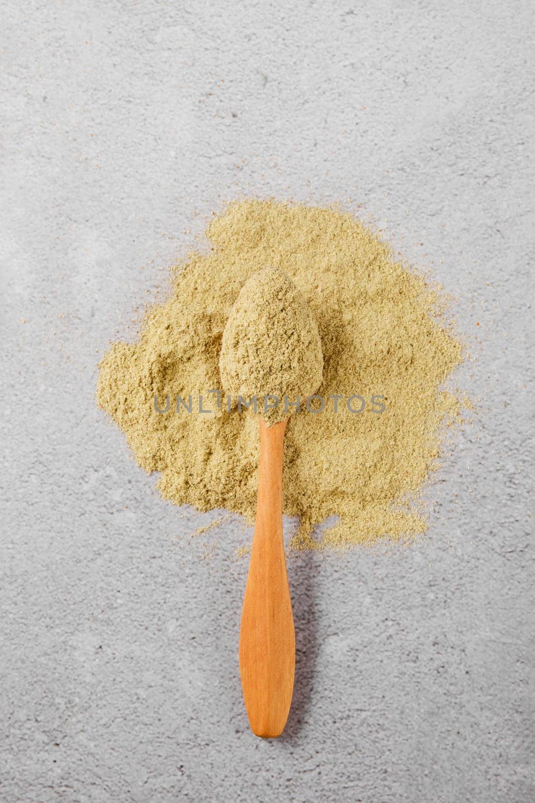 Overhead view of utskho suneli powder and wooden spoon
