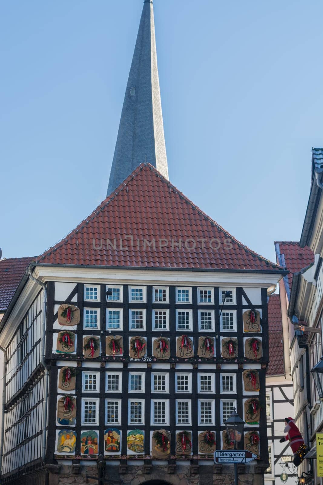 HATTINGEN OLD TOWN, NRW, GERMANY - DEZEMBER 05, 2016:  Huge Advent calendar on a half-timbered house in Hattingen. People at the Christmas market in Hattingen.