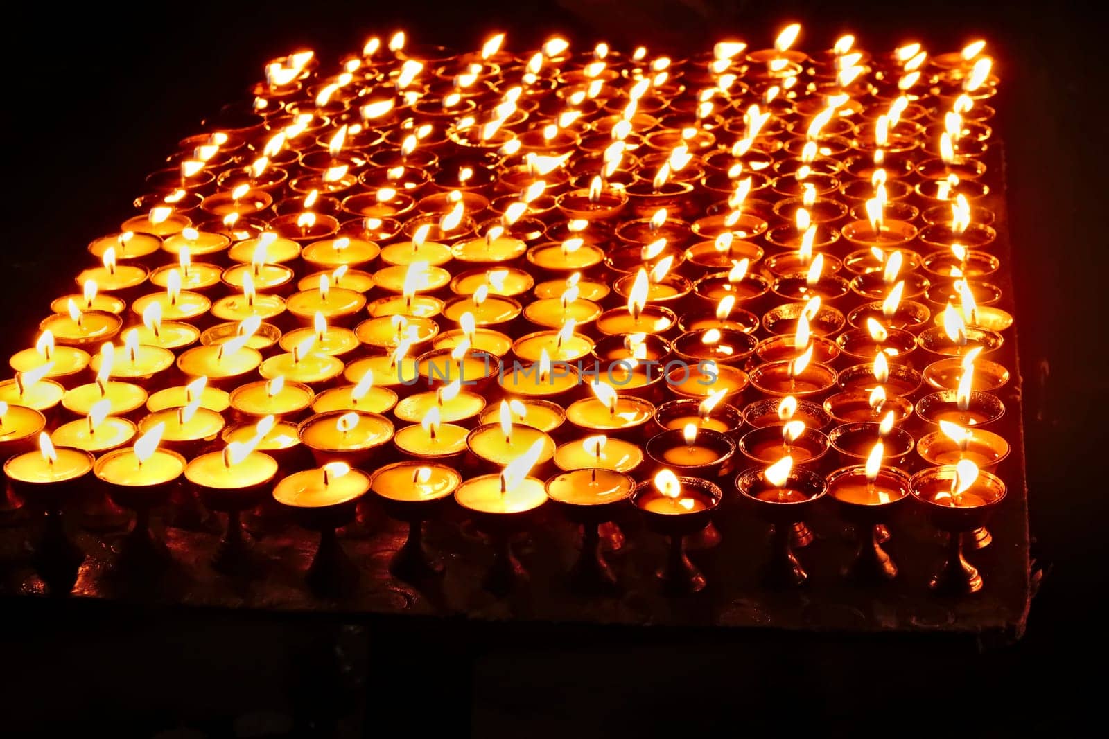 Many butter lamps, candles are burning at night at the Boudhanath Stupa in Kathmandu, Nepal 2022
