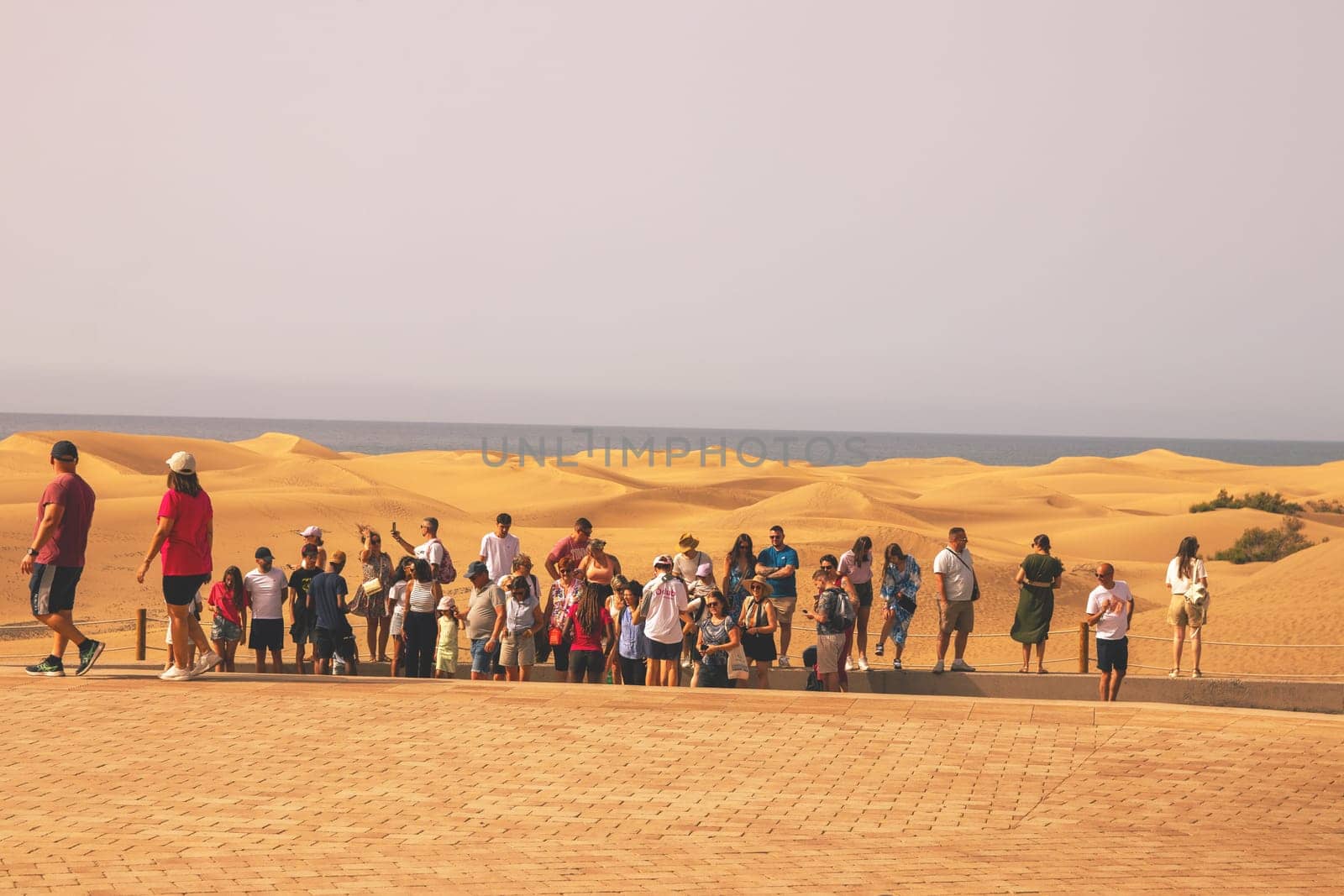 Gran Canaria, Spain, Canary Islands, Playa del Inglés - JUL 17, 2024. Tourist at a viewpoint of Dunes de Maspalomas. Maspalomas Dunes Nature Reserve.