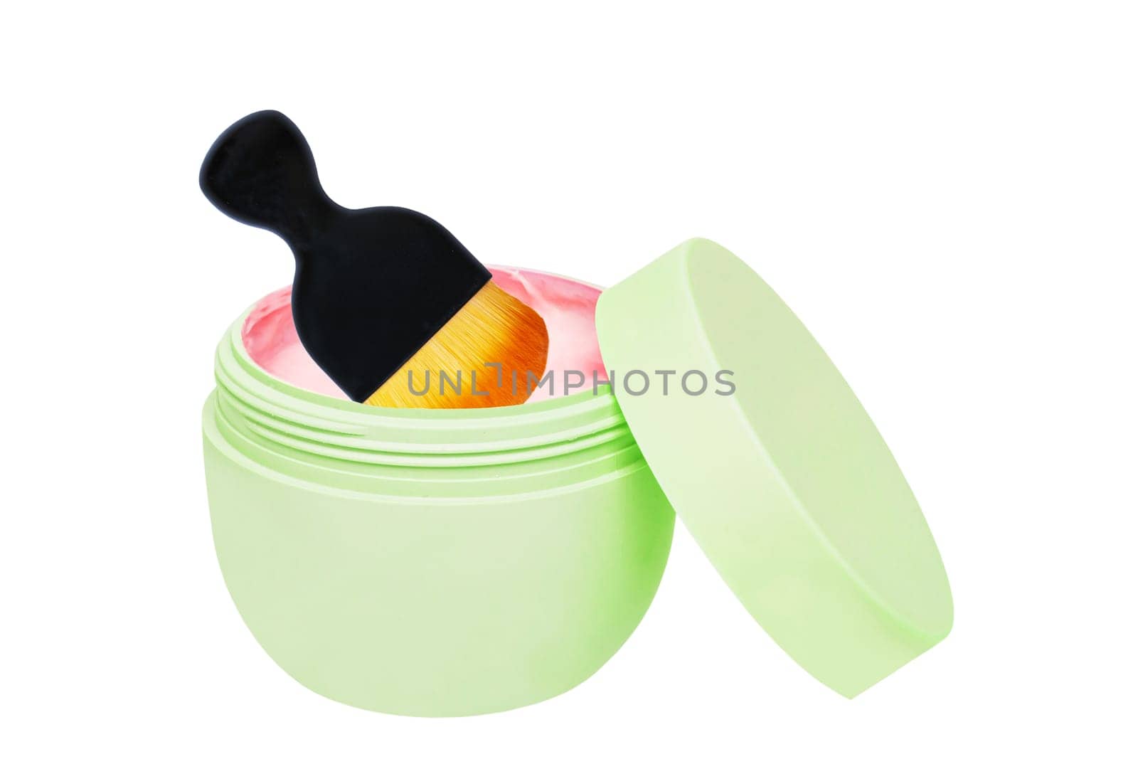 Closeup of an open cosmetic jar of concealer cream, makeup foundation, moisturising cream for the face and a brush. Clipping path. Beauty or make-up product.
