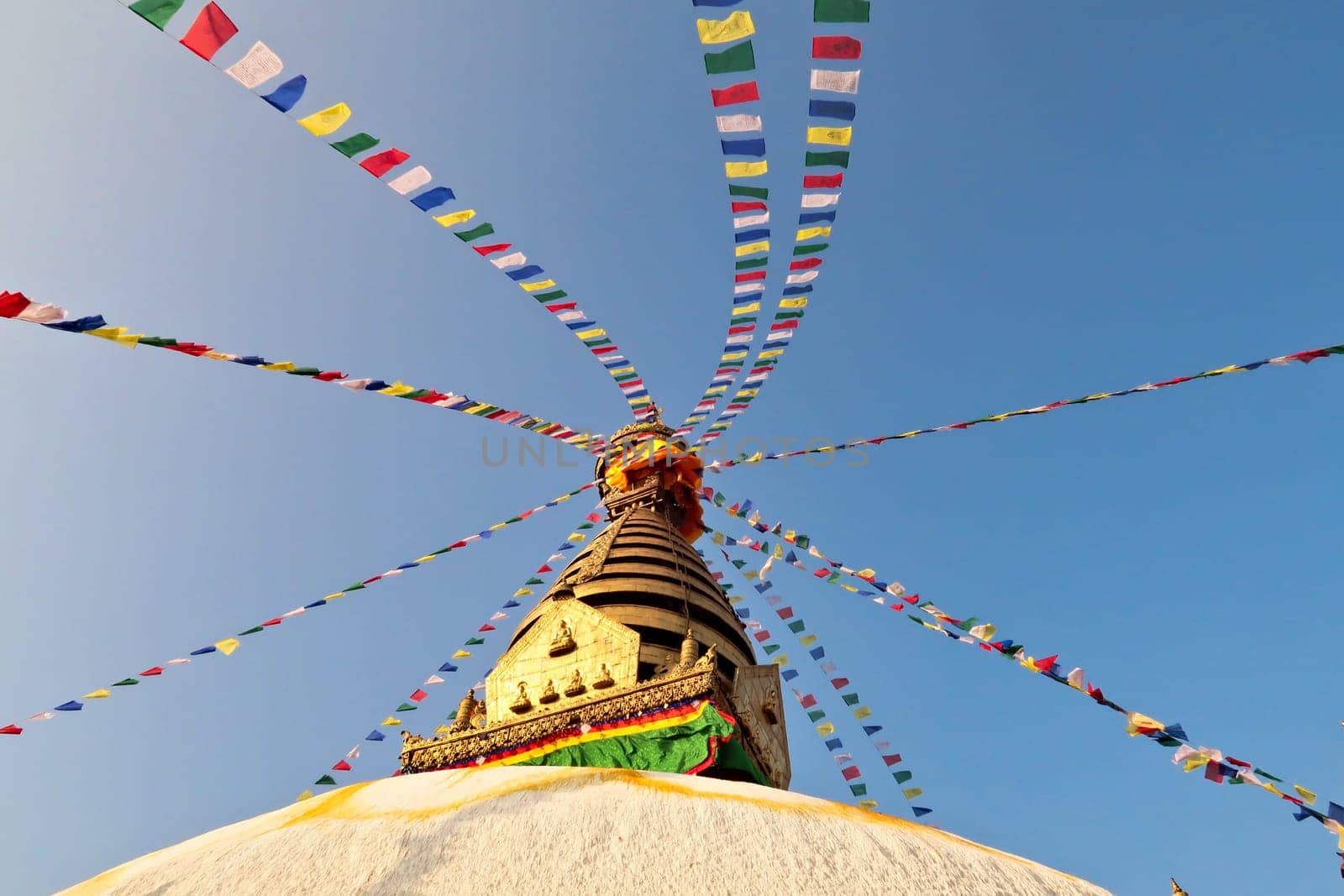 The top of the Swayambhunath Stupa, Temple, decorated with many colorful prayer flags, Kathmandu, Nepal 2022