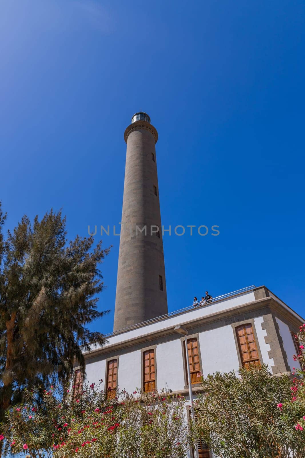 Gran Canaria, Spain: March 20, 2024: People at the Maspalomas Lighthouse in Gran Canaria Canary Island.This highest lighthouse on the island,a landmark in this important tourist destination