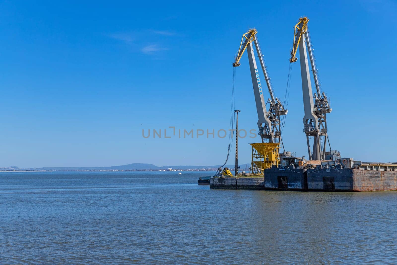 Lisbon, Portugal: April 12, 2024: Industrial port of Belem in Tagus river, Lisbon, Portugal