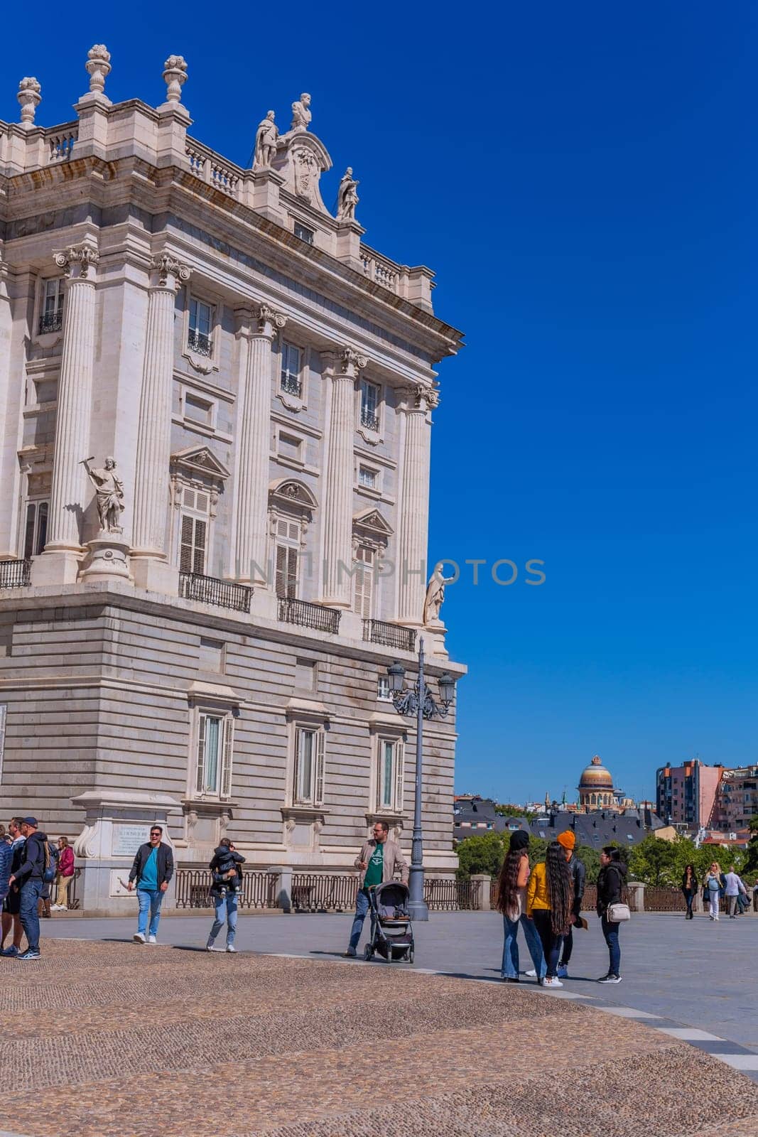 Madrid, Spain: April 24, 2024: Tourists at the Royal Palace in Madrid, Spain. Royal Palace of Madrid - is official residence of Spanish Royal Family. Madrid, Spain