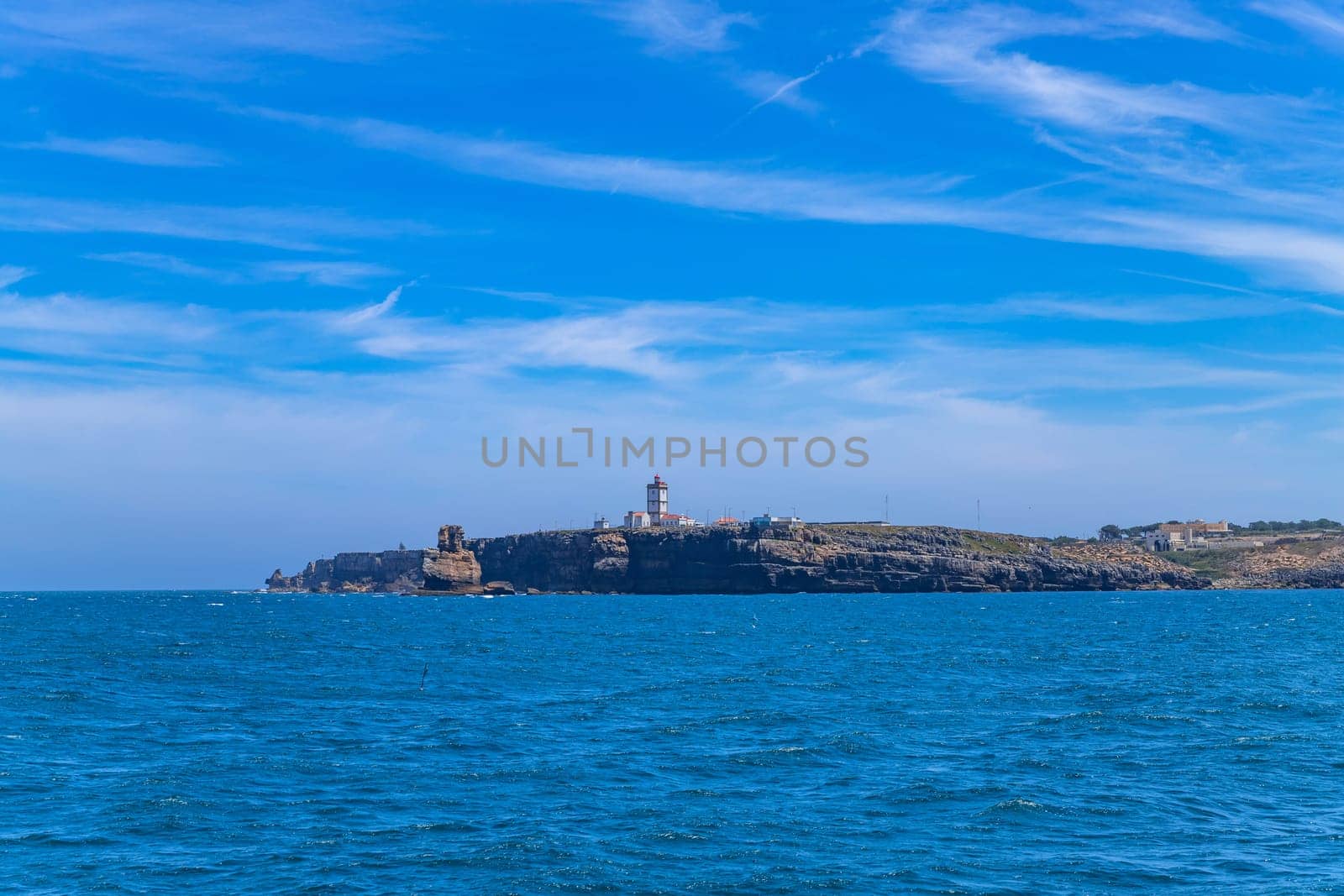 Lighthouse and cliffs of Carvoeiro cape in Peniche, Atlantic coast, Portugal