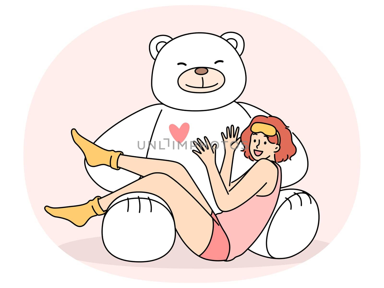 Giant teddy bear near sitting teenage girl in pajamas and sleep mask. Funny schoolgirl teen age looks at screen lying on feet of toy bear rejoicing at cute gift from parents or boyfriend