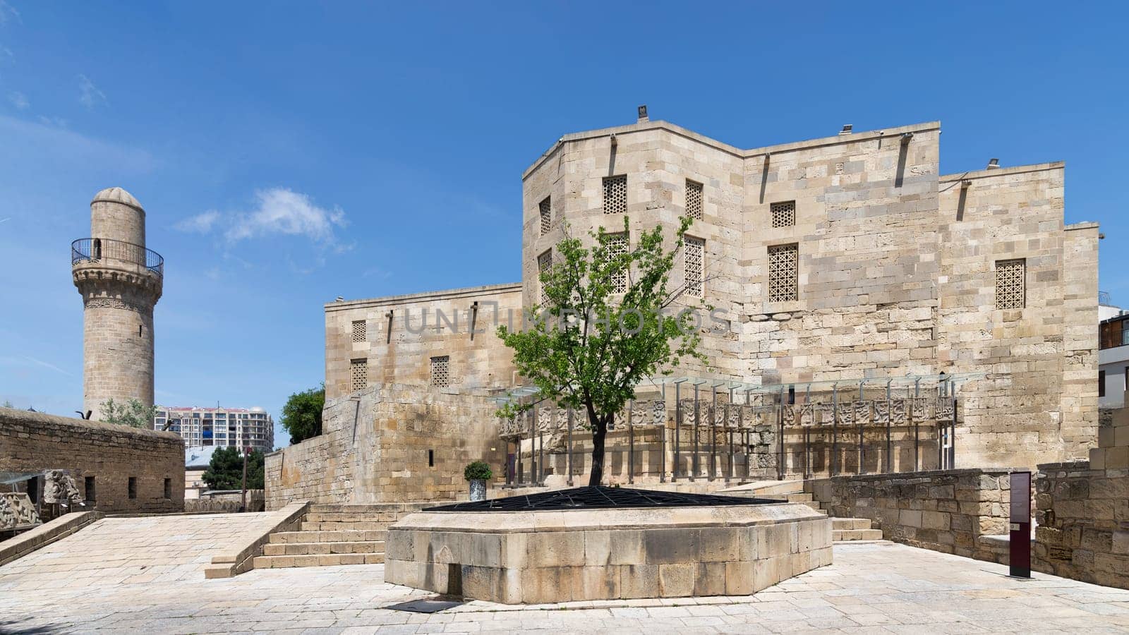 The historical Palace of the Shirvanshahs stands majestically in the Old City of Baku, Azerbaijan, showcasing intricate stonework under a vibrant blue sky