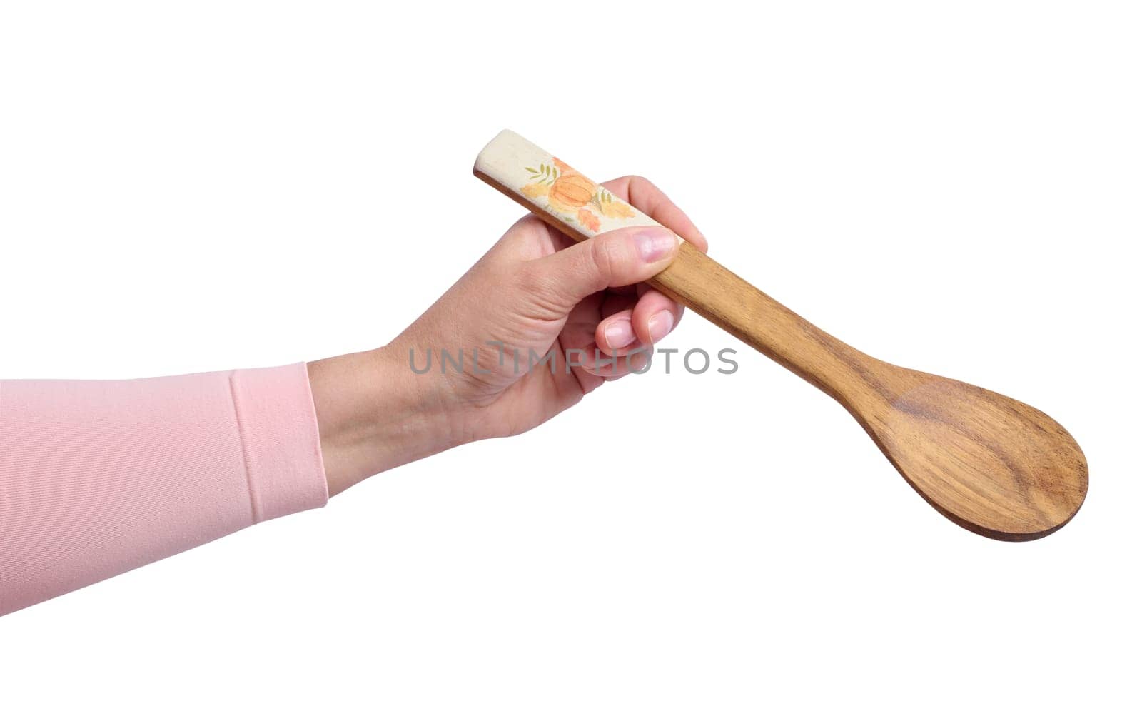 A woman's hand holds a wooden spoon on a white background, close up