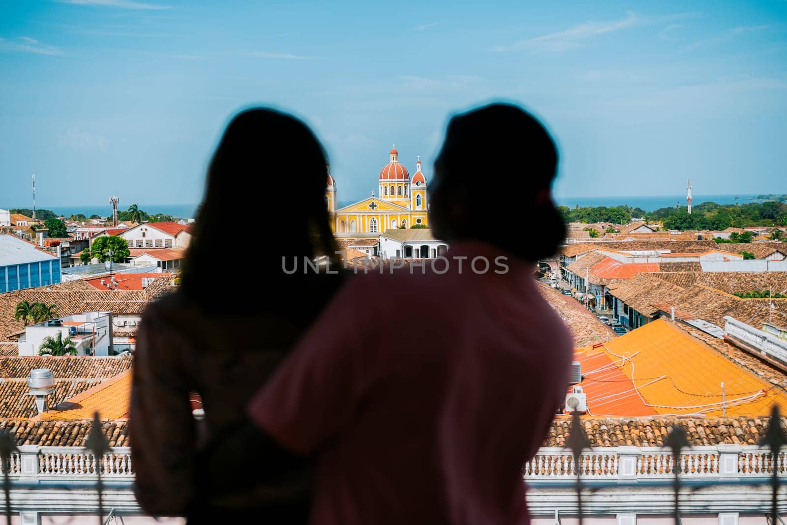 Silhouette of tourist couple looking at the Granada cathedral from the La Merced viewpoint