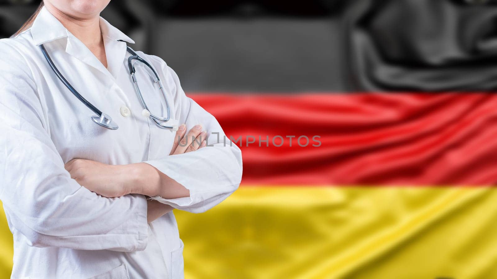 Female doctor with arms crossed with German flag in the background. Healthcare concept with Germany flag in background