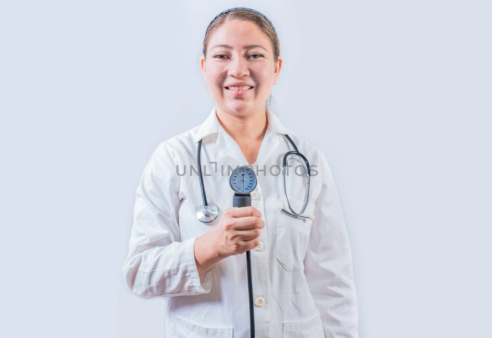 Young female doctor holding tensiometer on isolated background. Smiling female doctor showing blood pressure monitor isolated