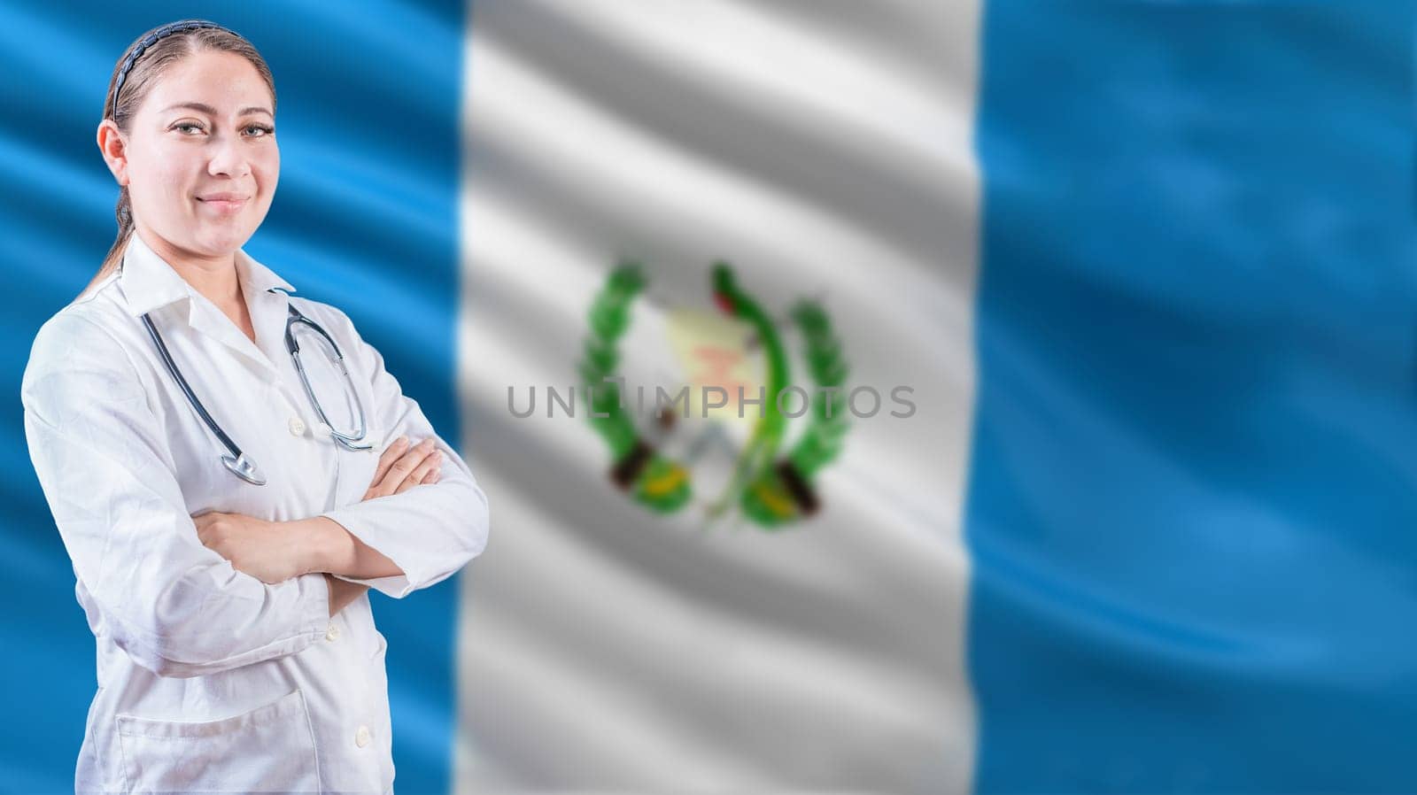 Female doctor with arms crossed with Guatemala flag background. Healthcare concept with Guatemalan flag in background
