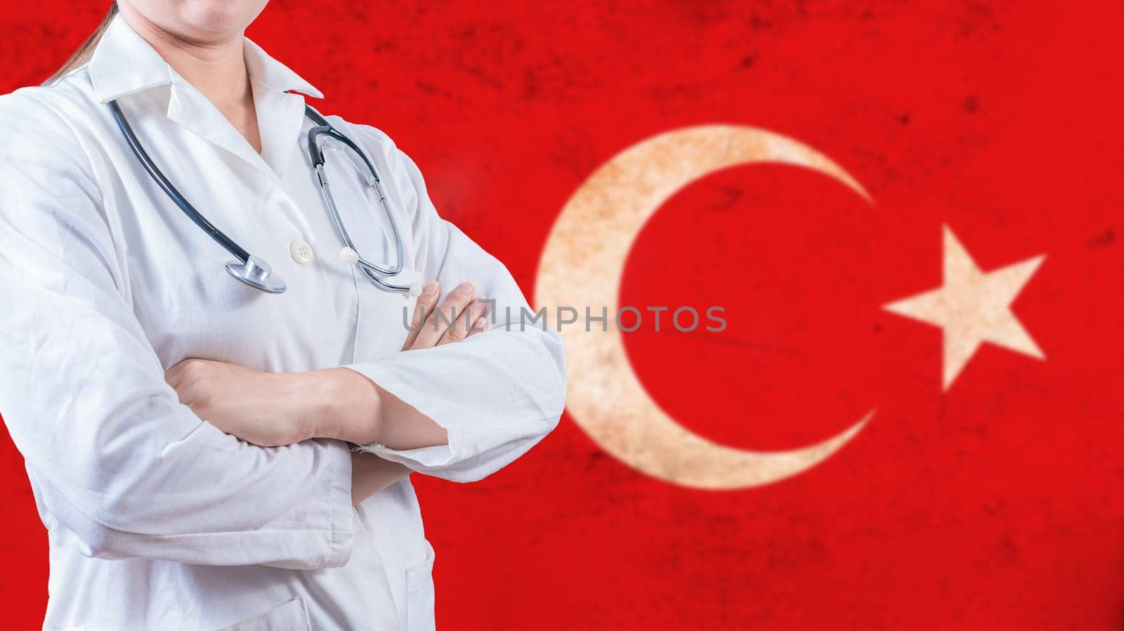 Healthcare concept with Turkish flag in background. Portrait of doctor with crossed arms with Turkish flag in the background