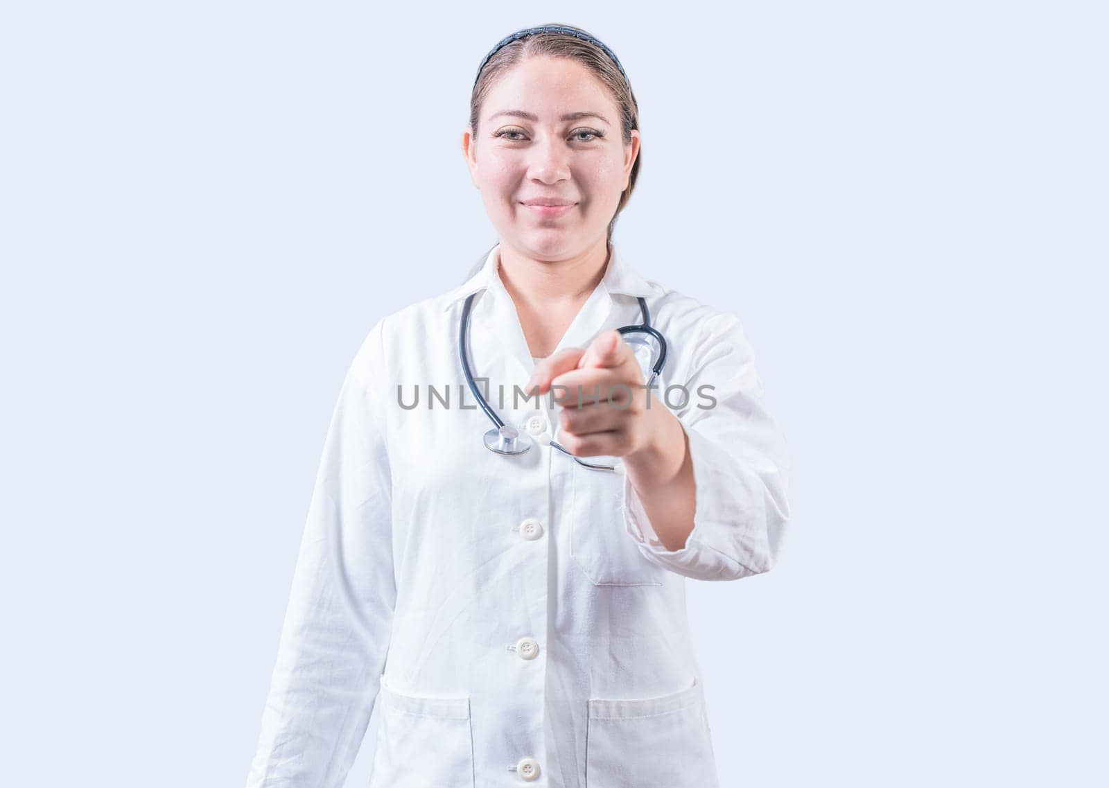 Smiling female doctor pointing at the camera. Happy female doctor pointing at you, Young doctor pointing at you