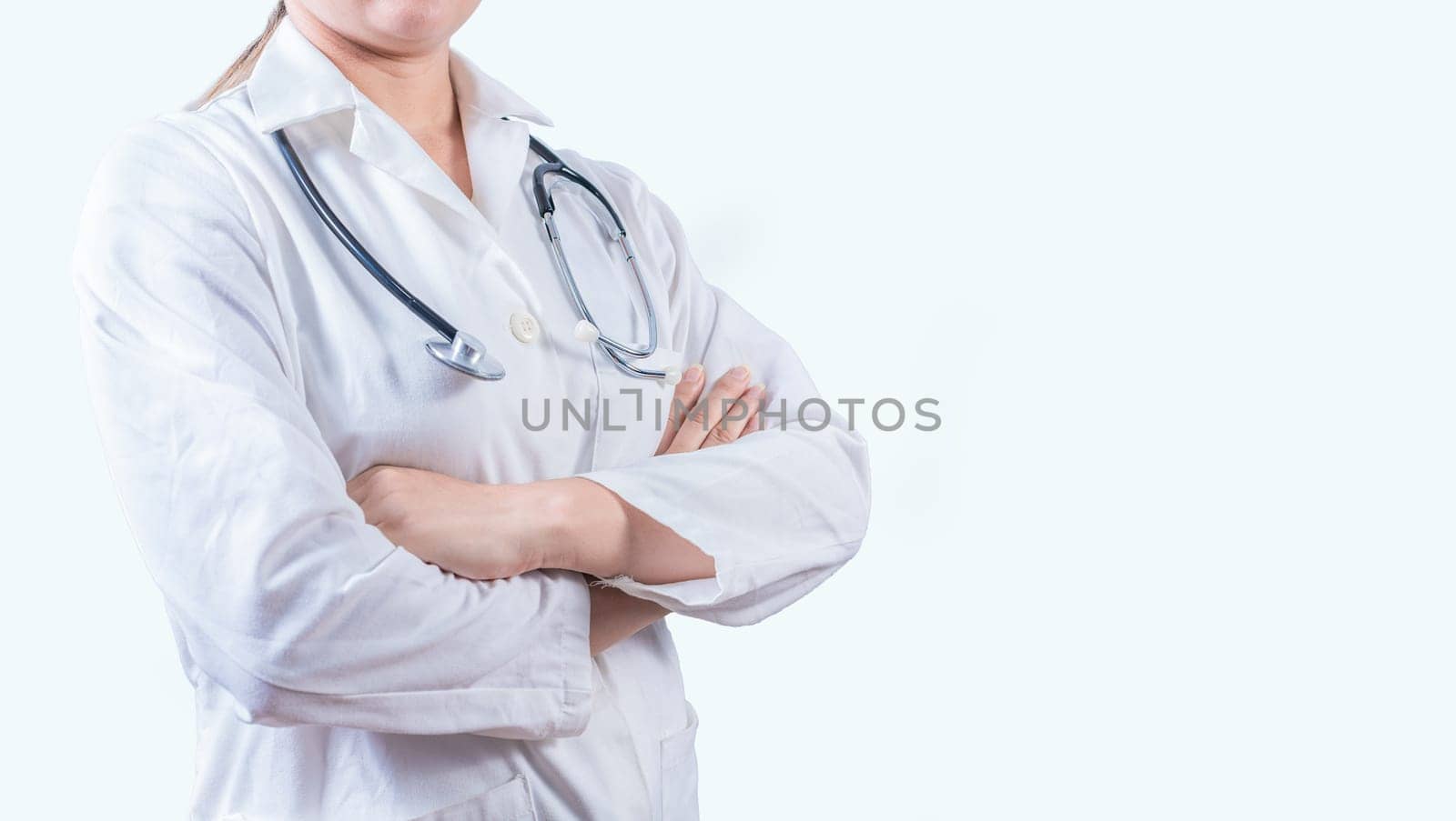 Unrecognizable female doctor with arms crossed with copy space. Crossed arms medical doctor banner