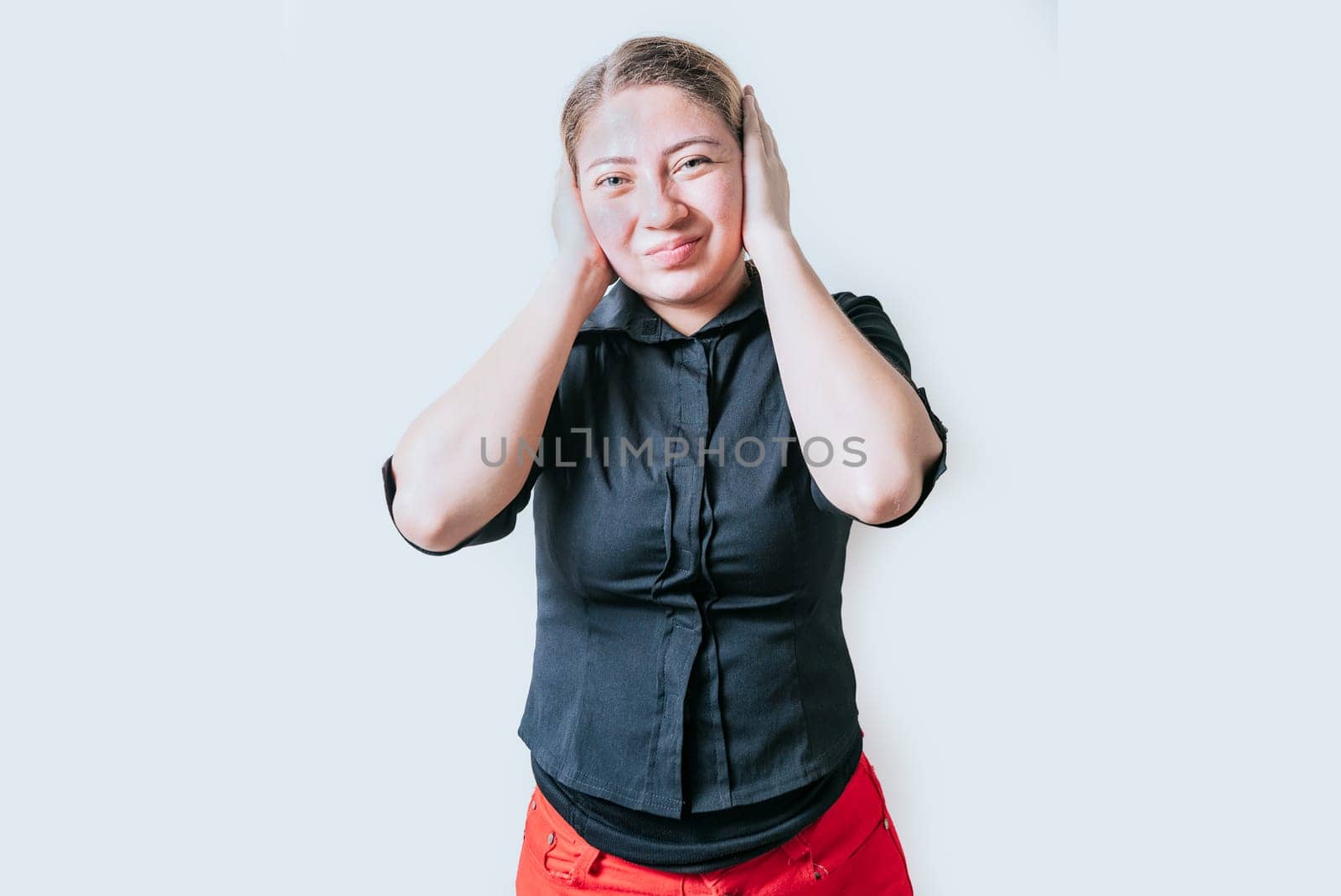 Displeased girl in glasses covering her ears isolated. Frustrated woman covering her ears tightly