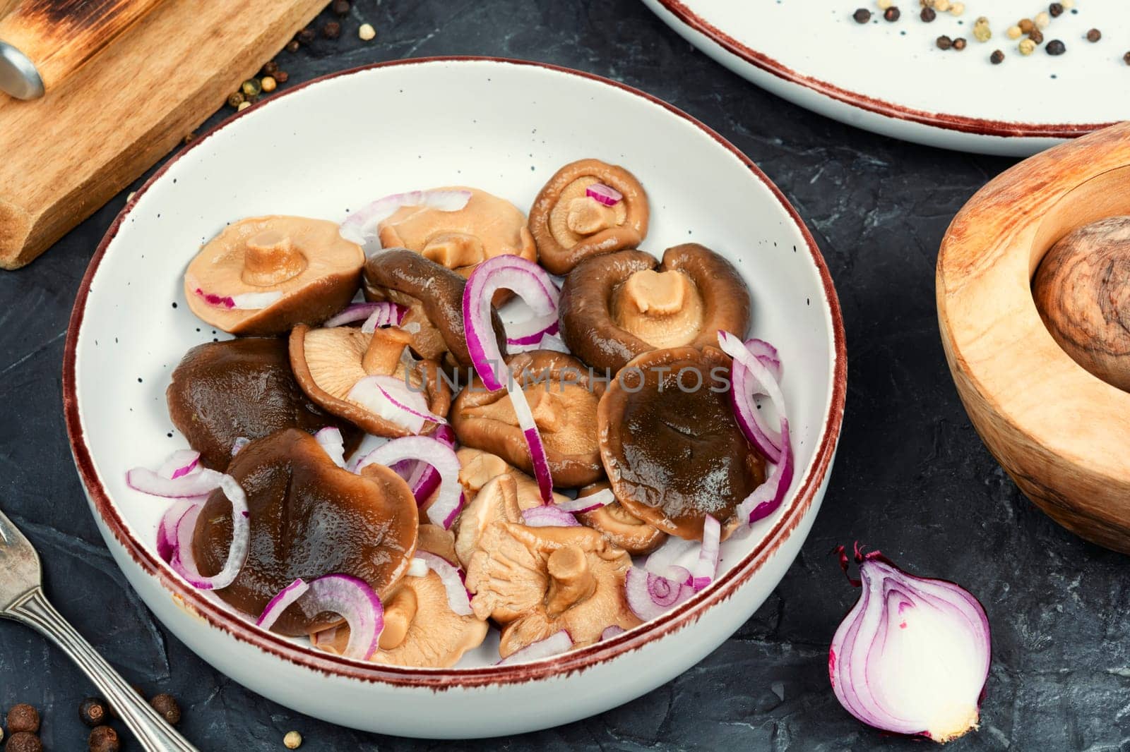 Salted mushrooms in a plate. Homemade marinated mushrooms.