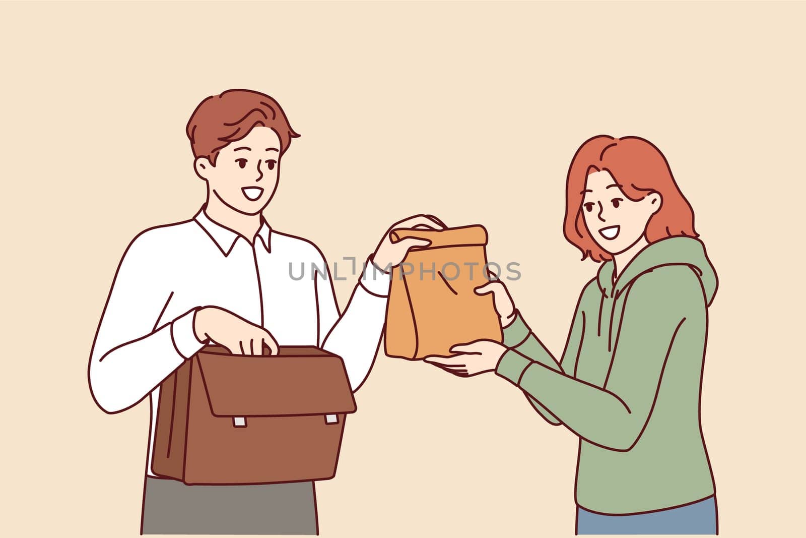 Man takes home-made lunch to work, from hands of loving wife caring for husband. Sandwich bag for delicious lunch for office employee who doesnt want to eat fast food or unhealthy processed foods.
